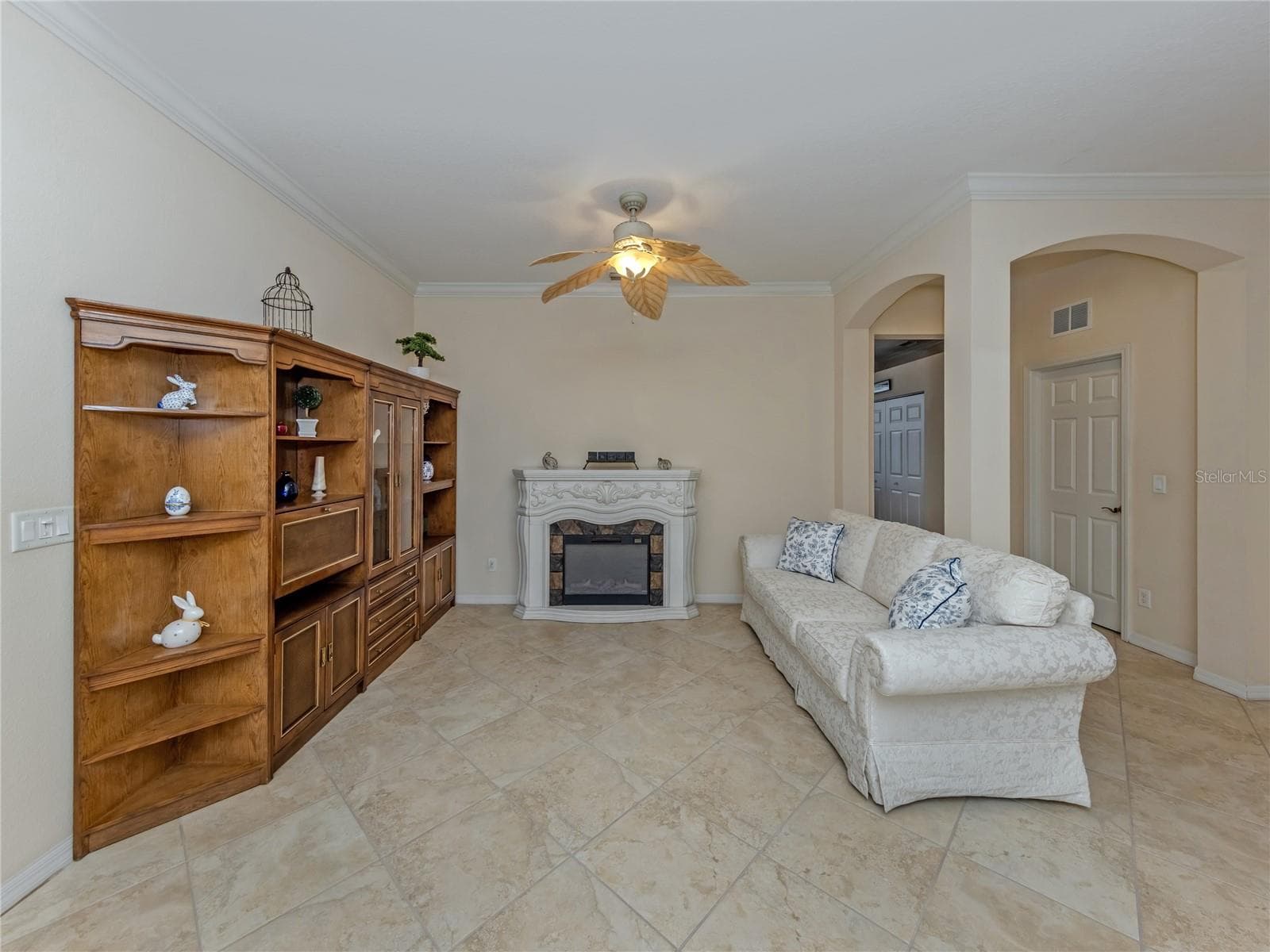 Formal Living Room, with Crown molding leading to Den/4th bedroom - 20702 CAPELLO DR, VENICE