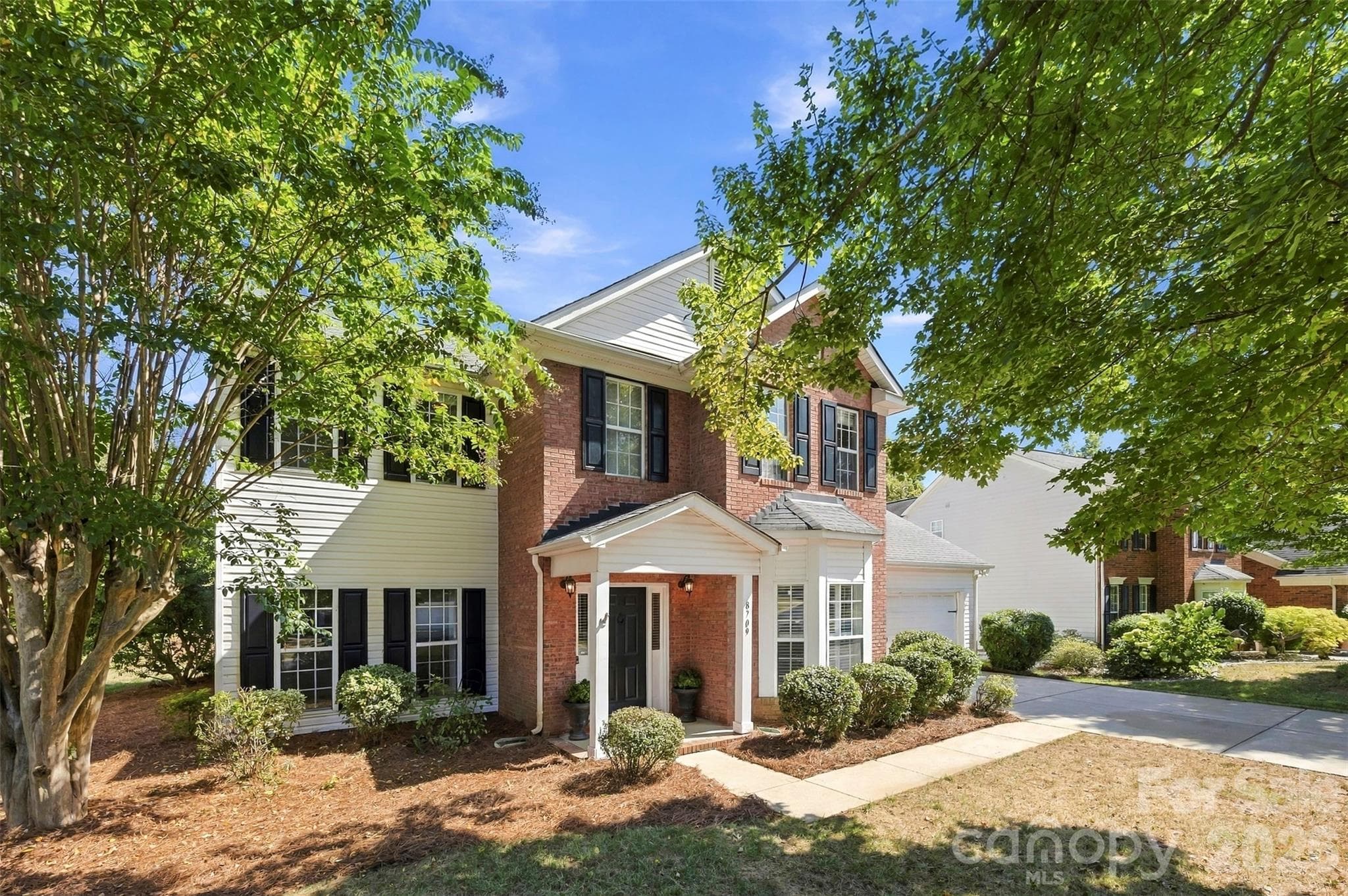 Front view with mature landscaping - 8709 Ellington Park Drive, Charlotte
