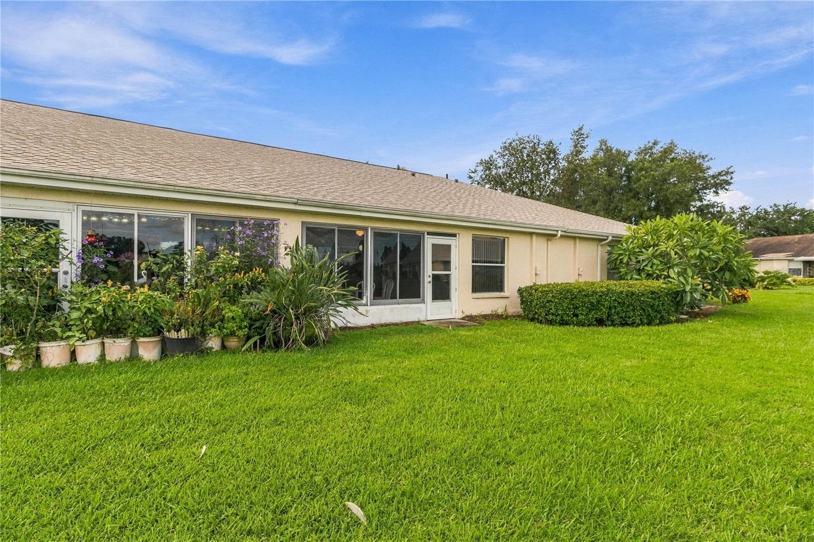 Take in the peaceful setting from the back of the home, overlooking the pond and backyard - 1002 NICENE CT #47, SUN CITY CENTER