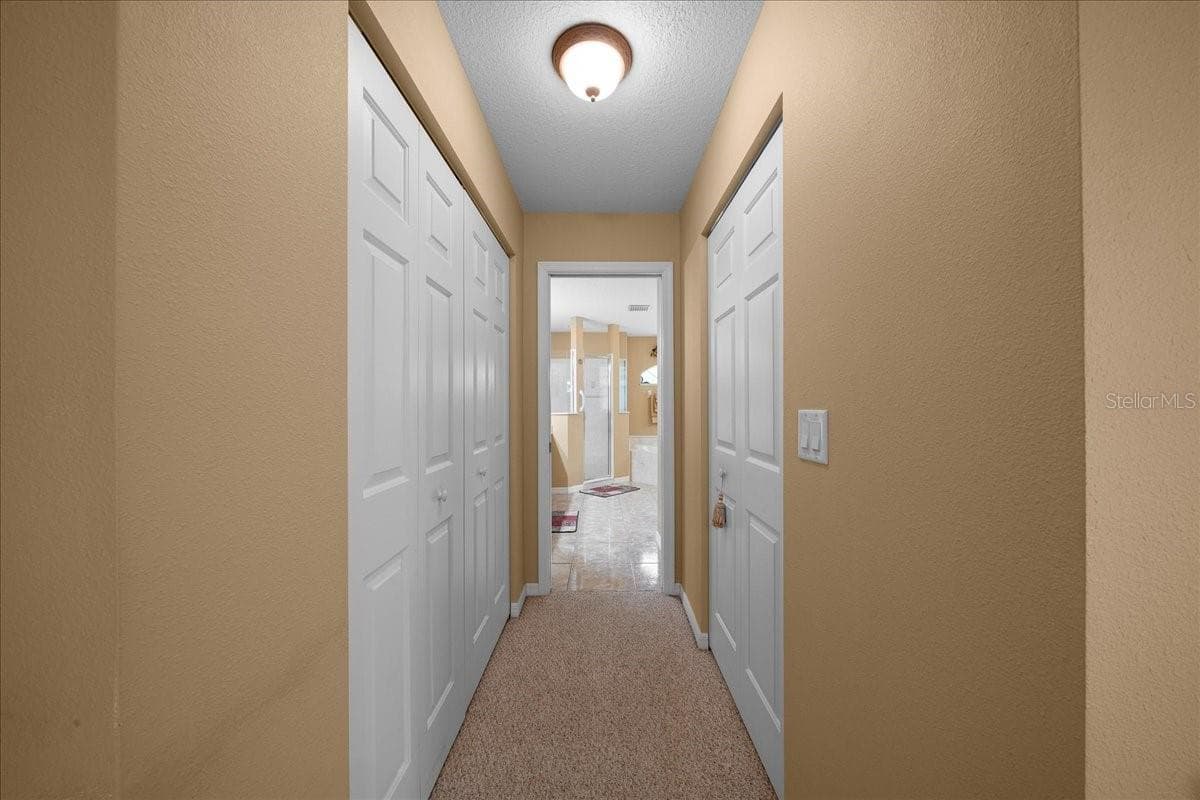 Dual Closet Hallway to bathroom - 8479 SW 134TH AVE, DUNNELLON