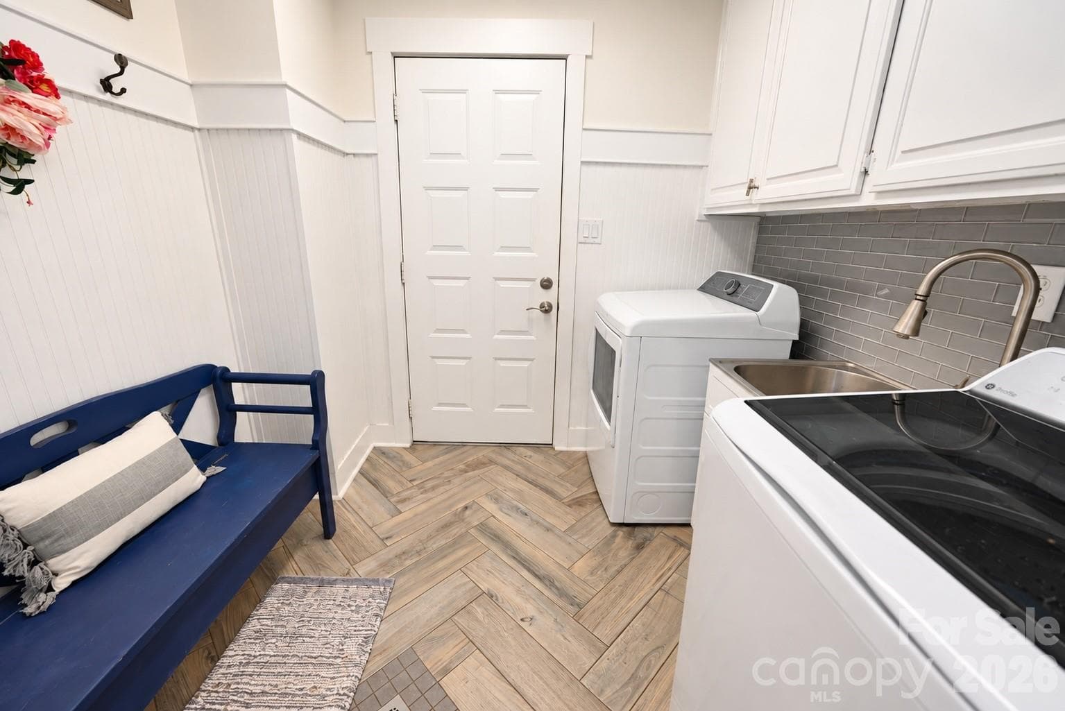 Laundry Room with Sink on Main Level. Exits through garage or main hallway near primary bedroom. - 3789 Rock Bridge Drive NE, Conover