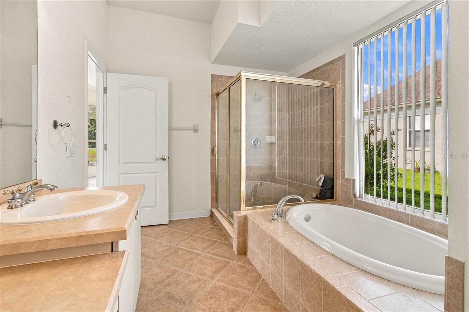 Your primary bathroom features a large window to allow plenty of sunlight into the room. - 1301 FOX CHAPEL DR, LUTZ