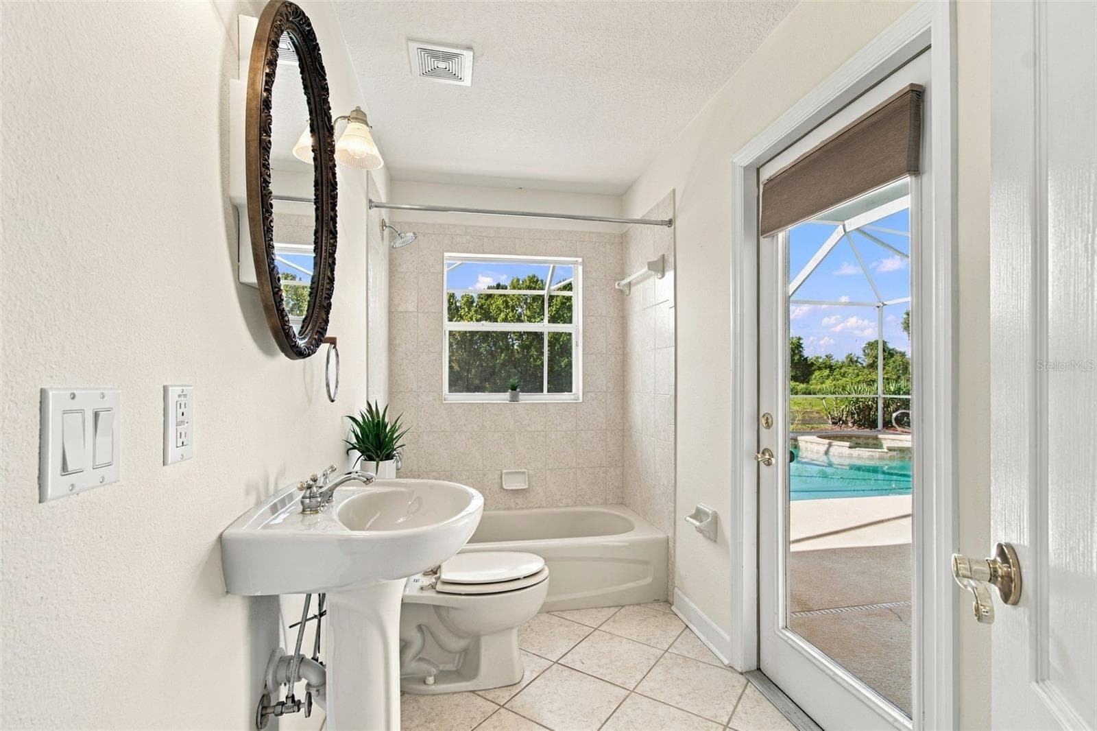 Secondary bathroom with easy access to the pool, spa and outdoor screened lanai. - 1301 FOX CHAPEL DR, LUTZ