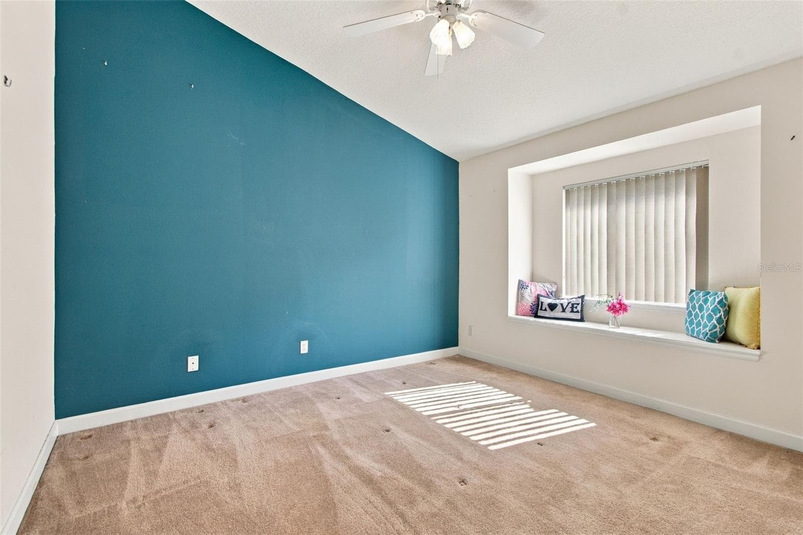 Secondary bedroom with window bench seating. - 1301 FOX CHAPEL DR, LUTZ