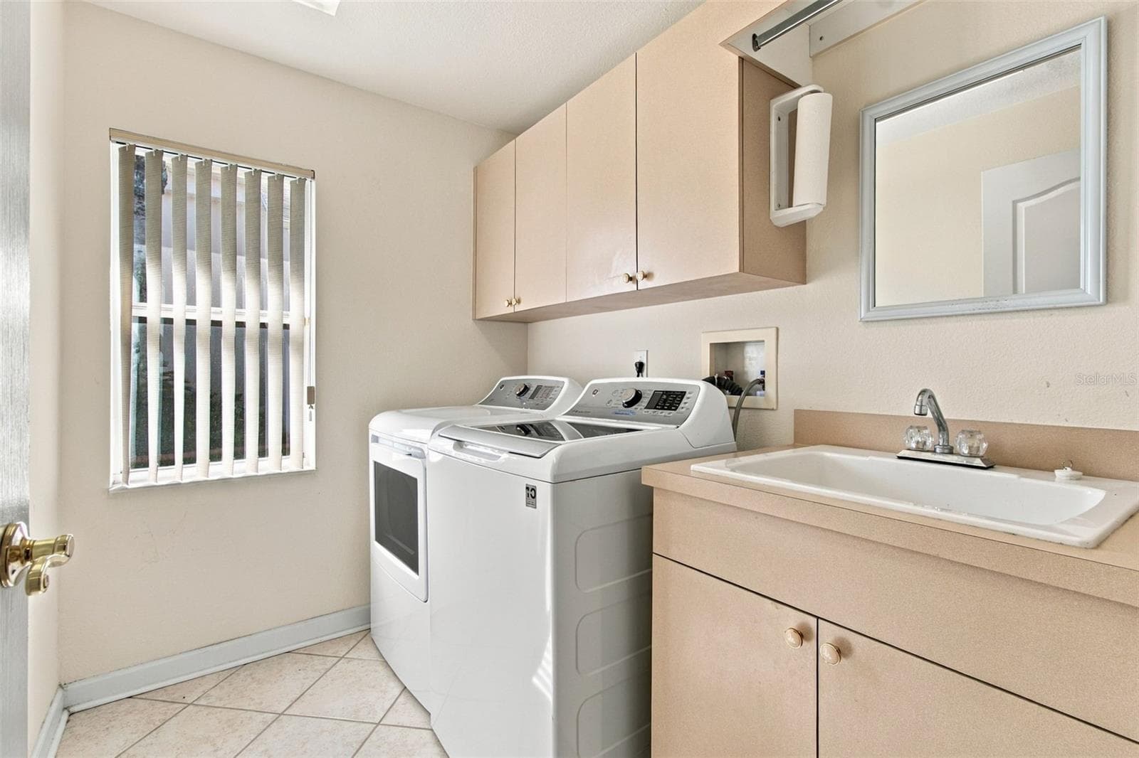 Your laundry has its own private entry and offers a window and a laundry sink! - 1301 FOX CHAPEL DR, LUTZ