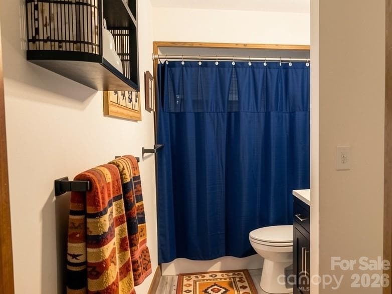 Main-level bathroom with convenient access from both the primary bedroom and hallway, offering comfort and functionality for residents and guests. - Lake Lure