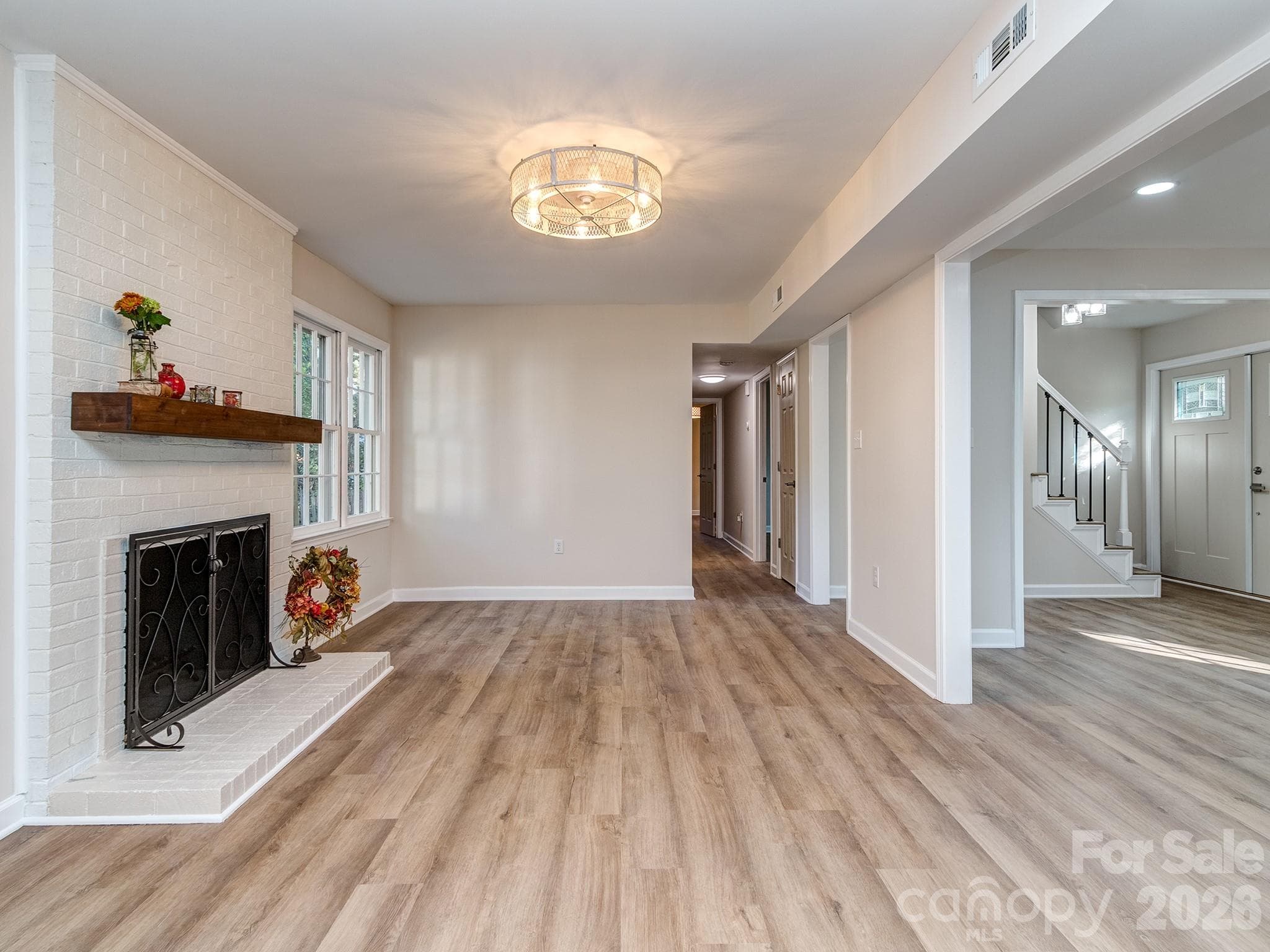 Living Room has a wood burning fireplace with options to put a large screen TV above fireplace or on the wall to its right. - 2041 Glouchester Circle, Charlotte