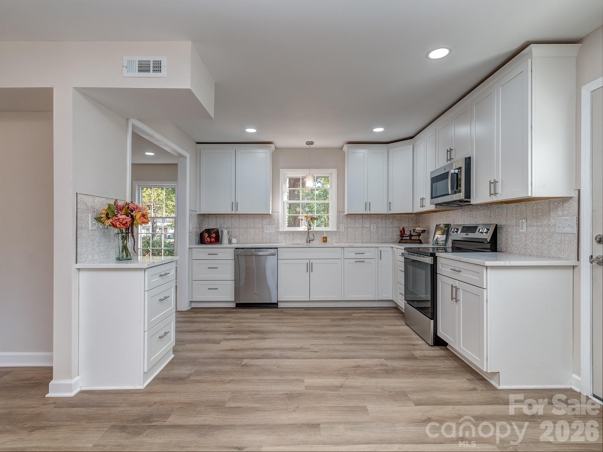 Kitchen has soft close cabinets, crown molding and a large stainless steel sink looking out over a beautiful front yard. - 2041 Glouchester Circle, Charlotte