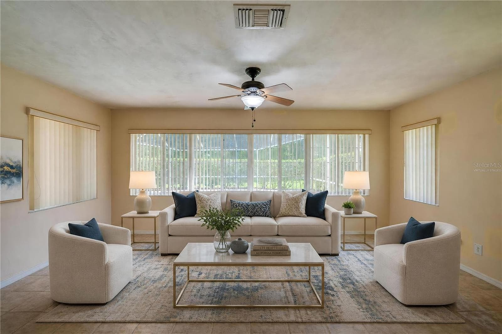 Virtually Staged - Bright enclosed sunroom equipped with light beige tile flooring, a ceiling fan, and wide windows fitted with vertical blinds for controlled light. - 4669 SECRET RIVER TRL, PORT ORANGE