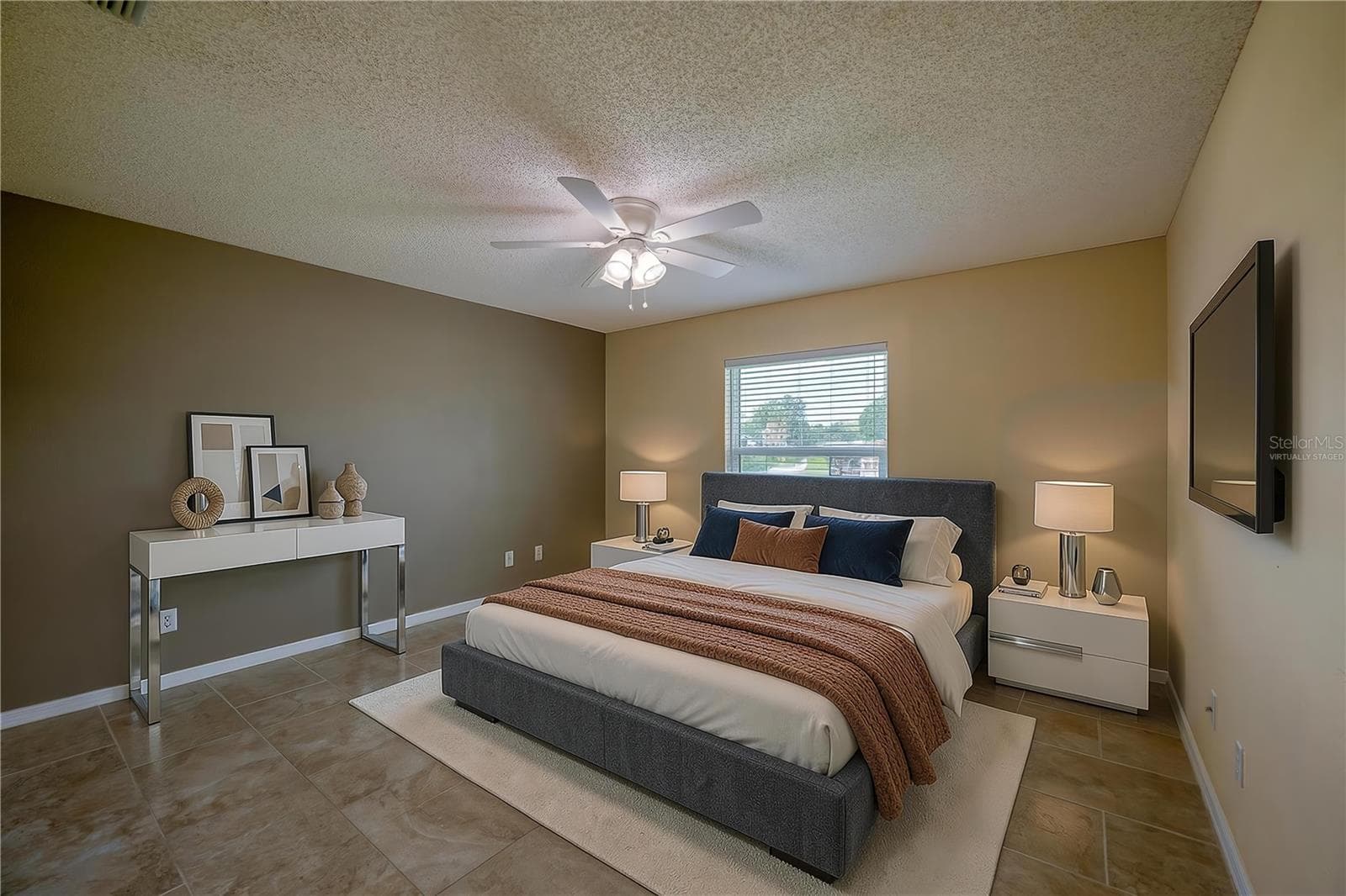 Virtually Staged - Generous bedroom featuring neutral tiled flooring, dual-tone walls, and a central ceiling fan with integrated lighting. Large window with blinds allows for ample natural light. - 4669 SECRET RIVER TRL, PORT ORANGE