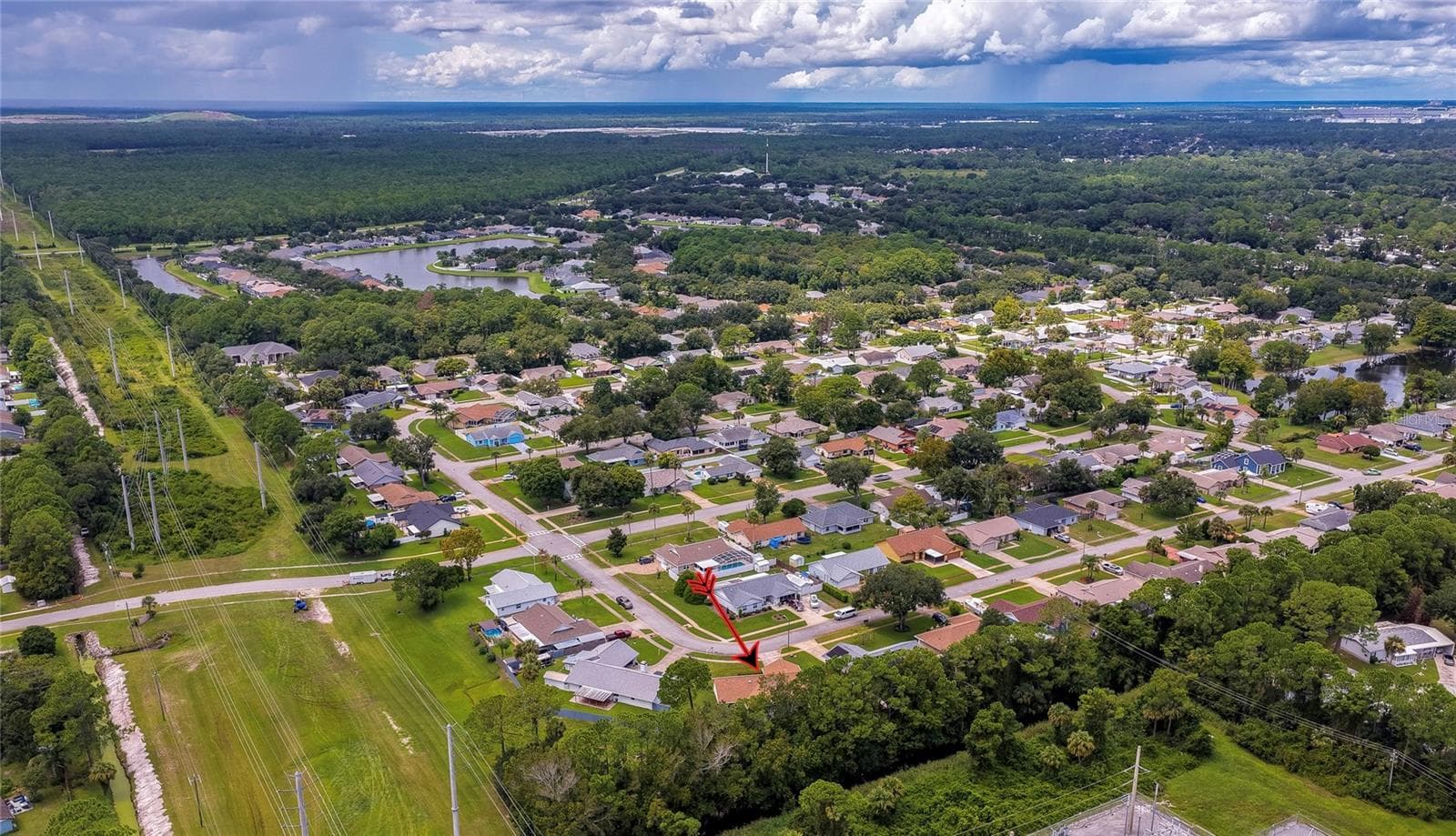 Panoramic aerial perspective illustrating the quiet, wooded neighborhood layout and expansive green canopy. - 4669 SECRET RIVER TRL, PORT ORANGE