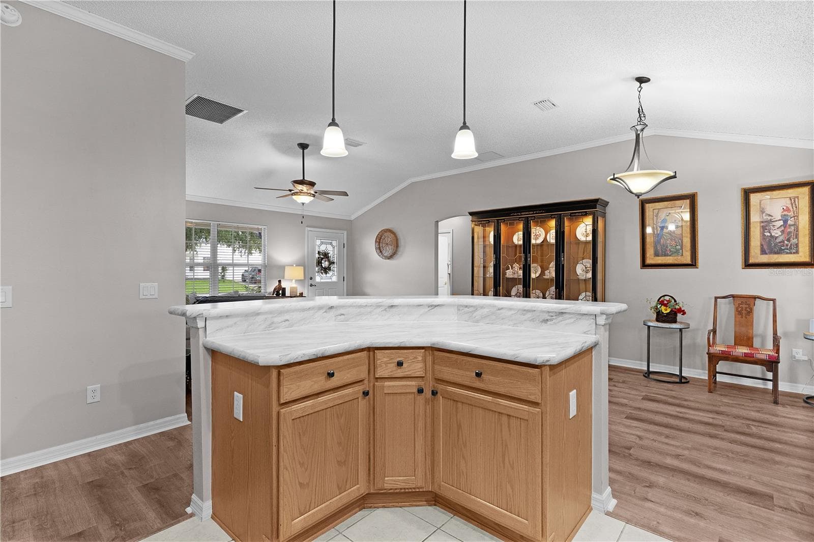 center island with cabinet drawers and pull out shelves - 2902 CHELTENHAM CT, THE VILLAGES