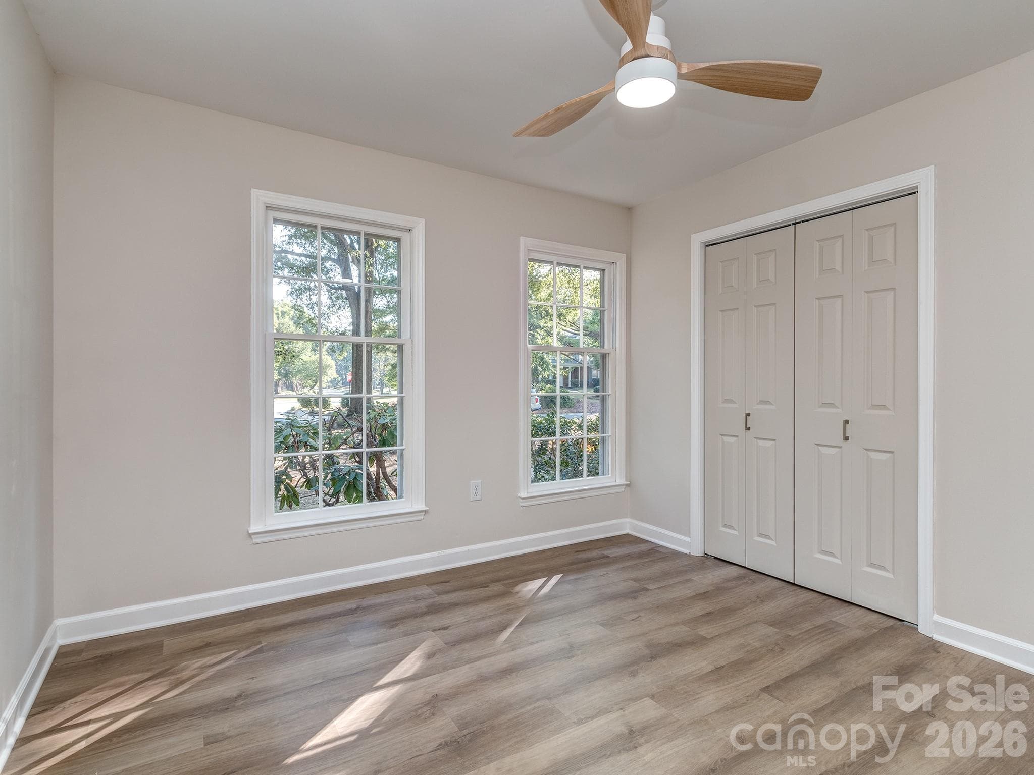 Bedroom #1 on the main floor can also be used as an office or bonus room. Big closet with organized shelving. - 2041 Glouchester Circle, Charlotte