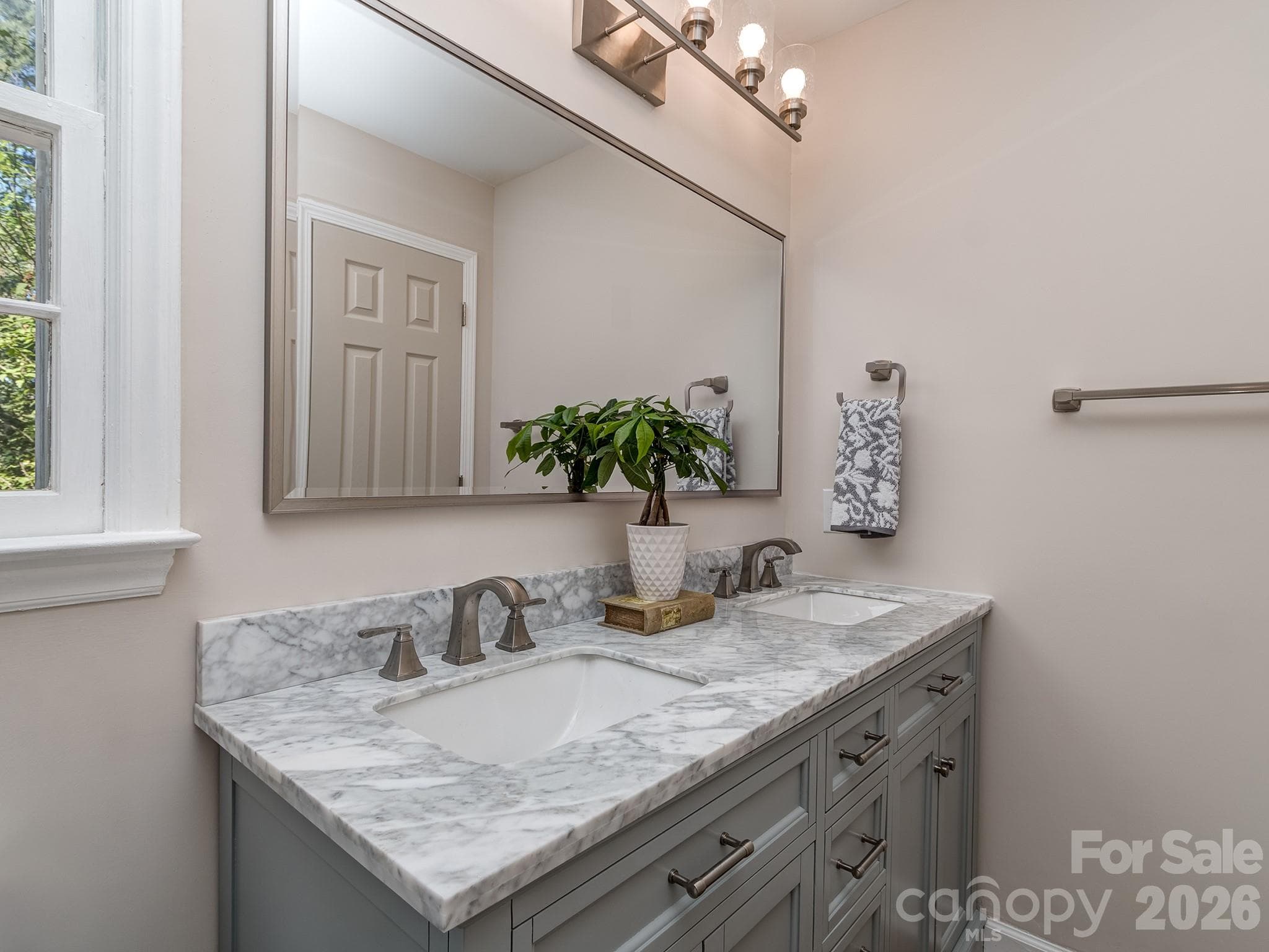 Upstairs Bath has a beautiful gray vanity with lots of storage for all your needs. Large mirror and double sinks allow for multi users to have their own space. - 2041 Glouchester Circle, Charlotte
