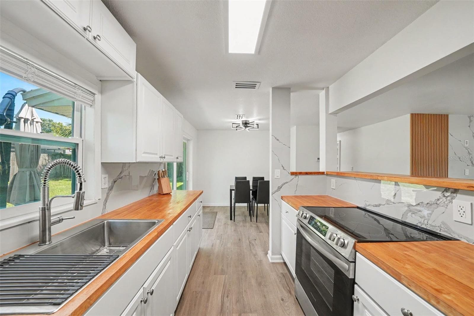 Kitchen has a nice window looking into the backyard. Very airy space. - 506 CAMBRIDGE CIR, SOUTH DAYTONA