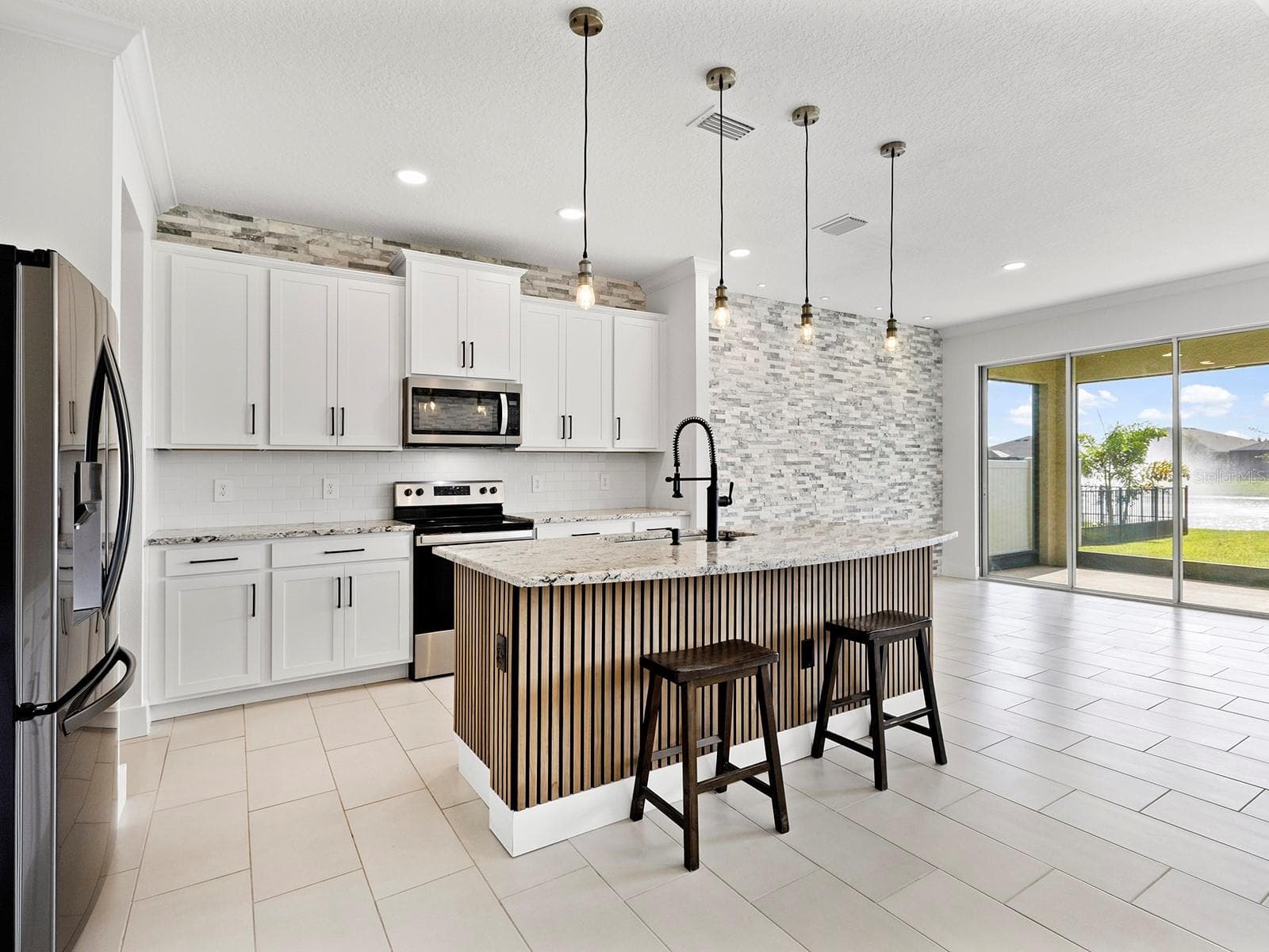 Kitchen with center island - 5211 TANNIN LN, BRADENTON