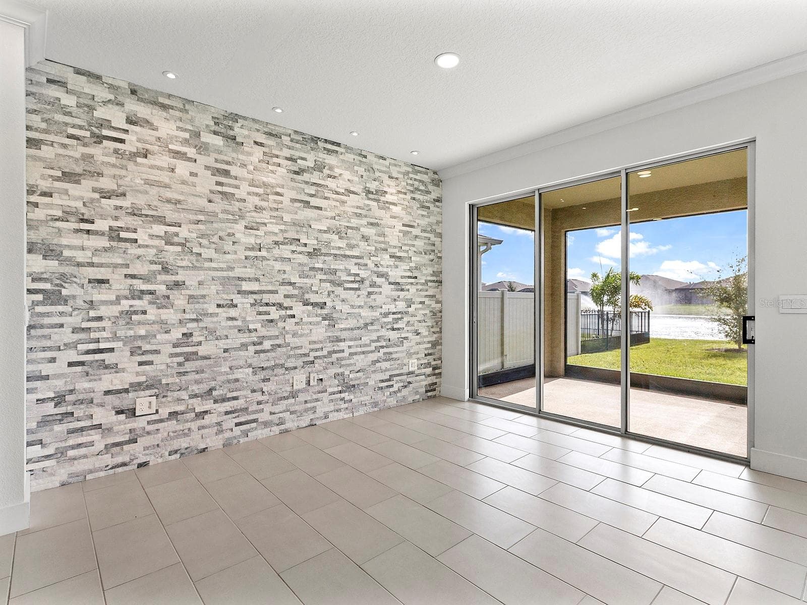 Formal dining room with accent wall stone - 5211 TANNIN LN, BRADENTON