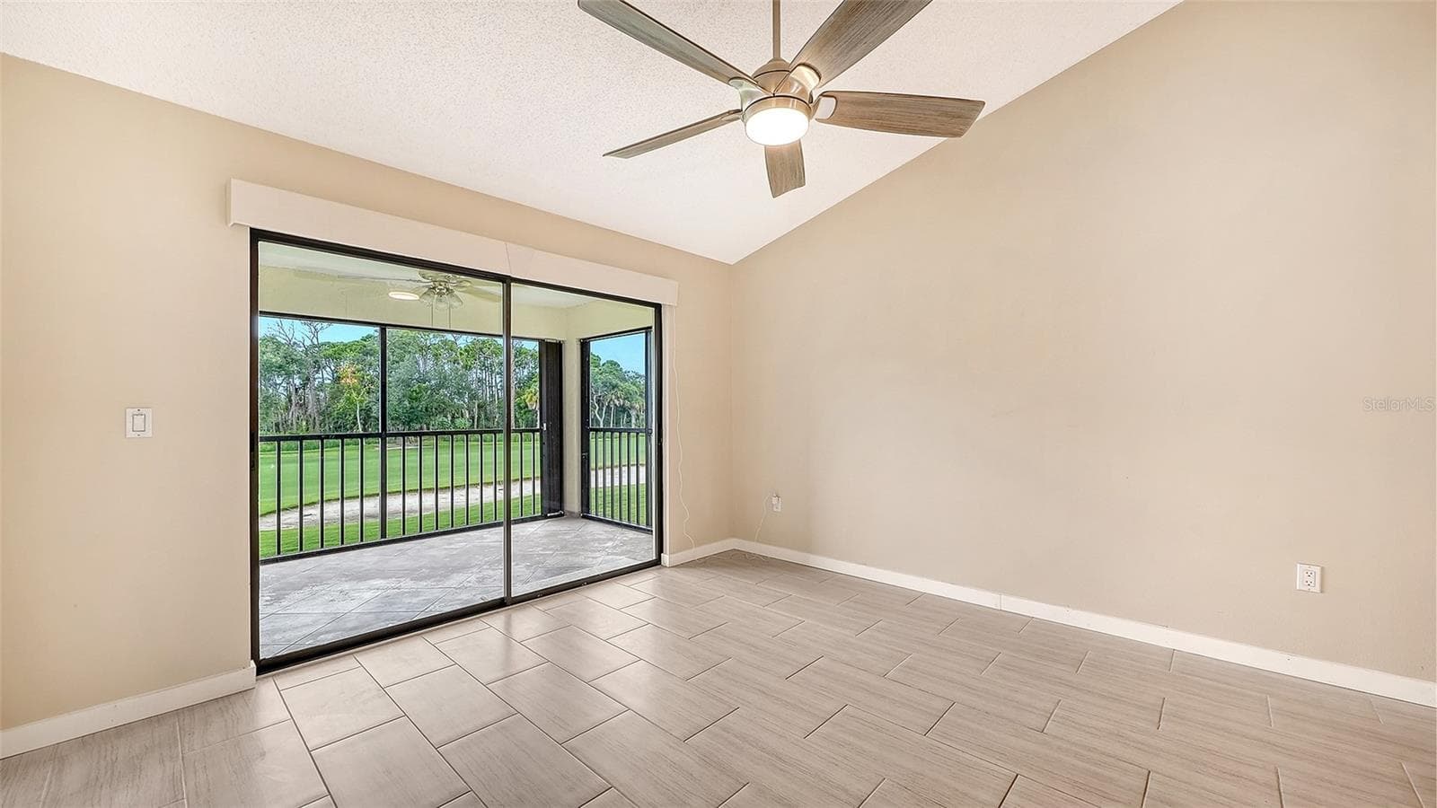 Living Room with newer Electric Sunscreen for Sliding Glass Door w Remote! - 7652 EAGLE CREEK DR #7598, SARASOTA