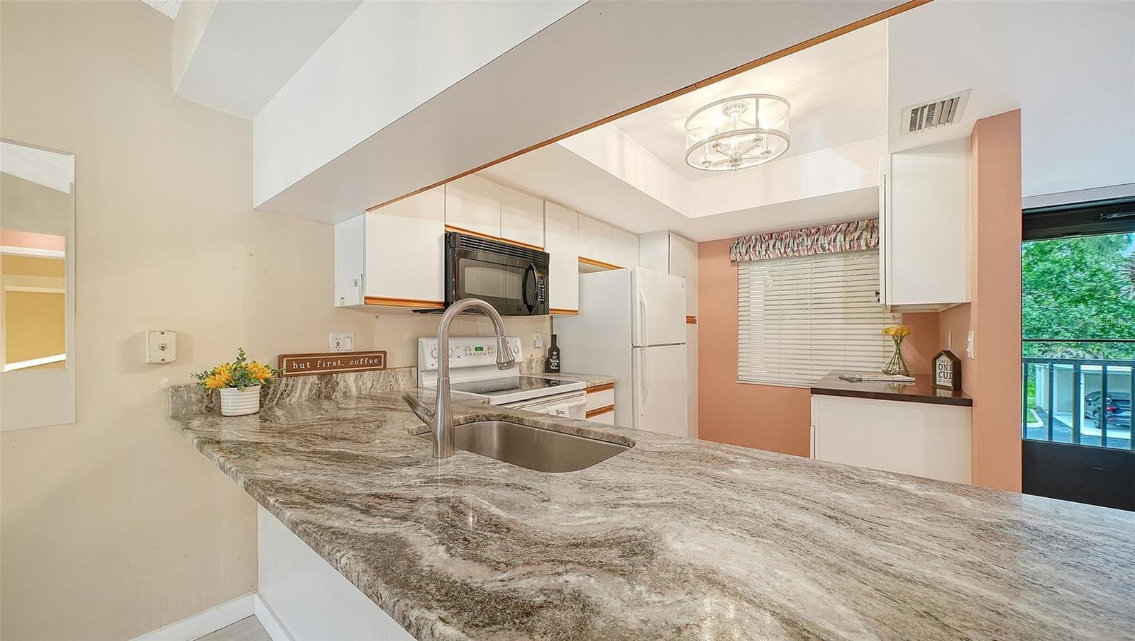 Kitchen with gorgeous Granite Countertops, newer Dishwashwer and additional Built-in Cabinetry, new light fixture. - 7652 EAGLE CREEK DR #7598, SARASOTA