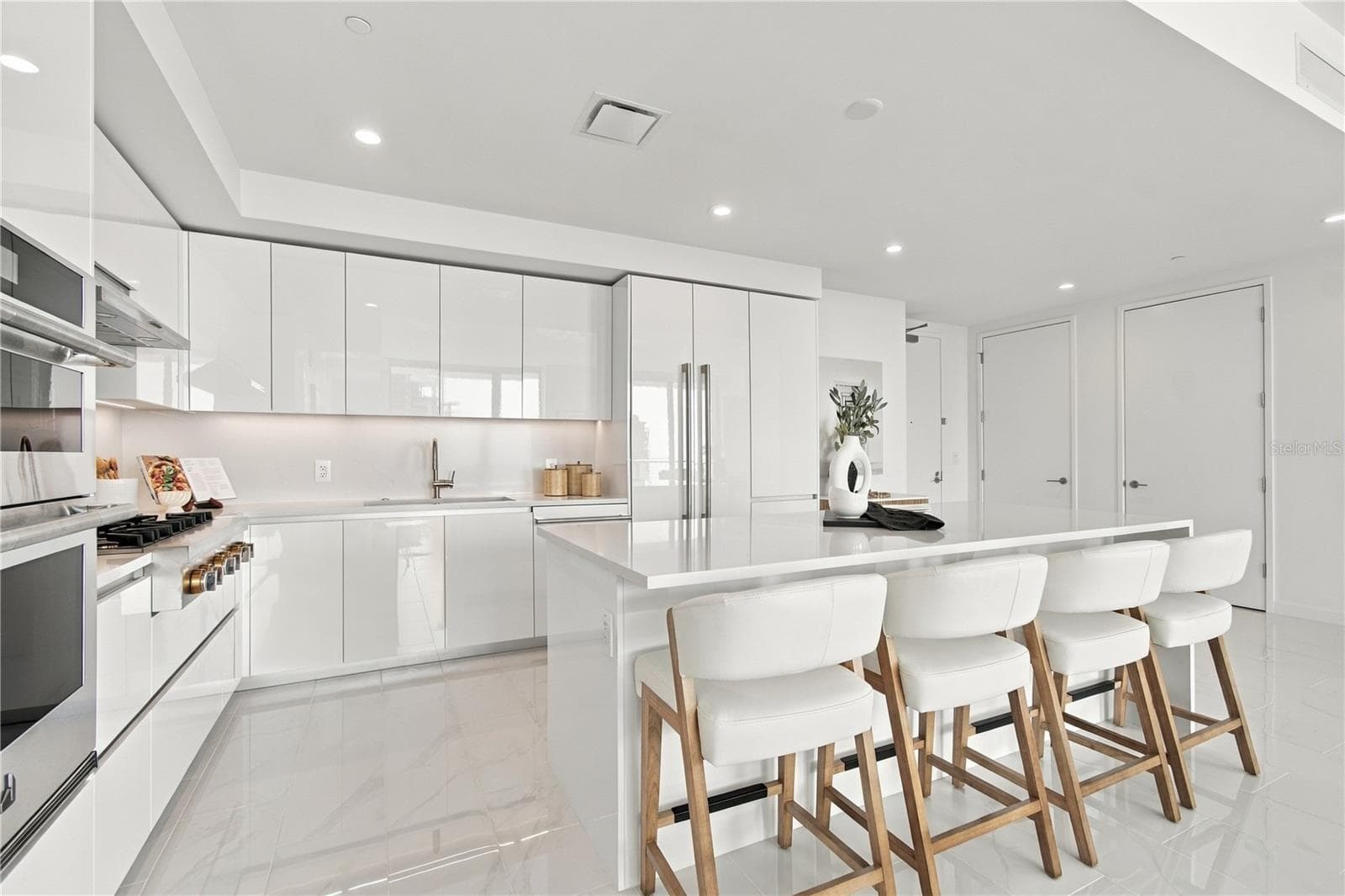 European-style kitchen features a large quartz island designed for gathering and entertaining - 400 CENTRAL AVE #2505, ST PETERSBURG