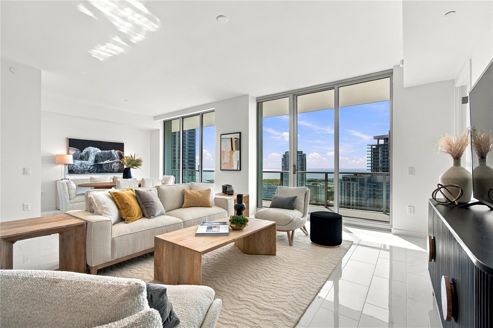 Professionally staged 28-foot great room showcases the exceptional scale and versatility of Residence 2505 - 400 CENTRAL AVE #2505, ST PETERSBURG