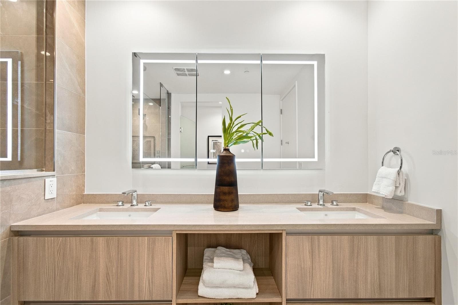 Custom vanity is complemented by a dramatic 60-inch illuminated touch-light medicine cabinet - 400 CENTRAL AVE #2505, ST PETERSBURG