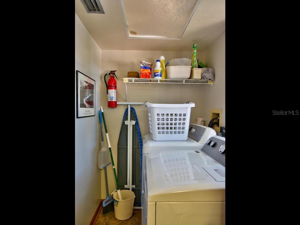 Laundry room has full size washer dryer off half bathroom - 2700 GULF BLVD #2, INDIAN ROCKS BEACH