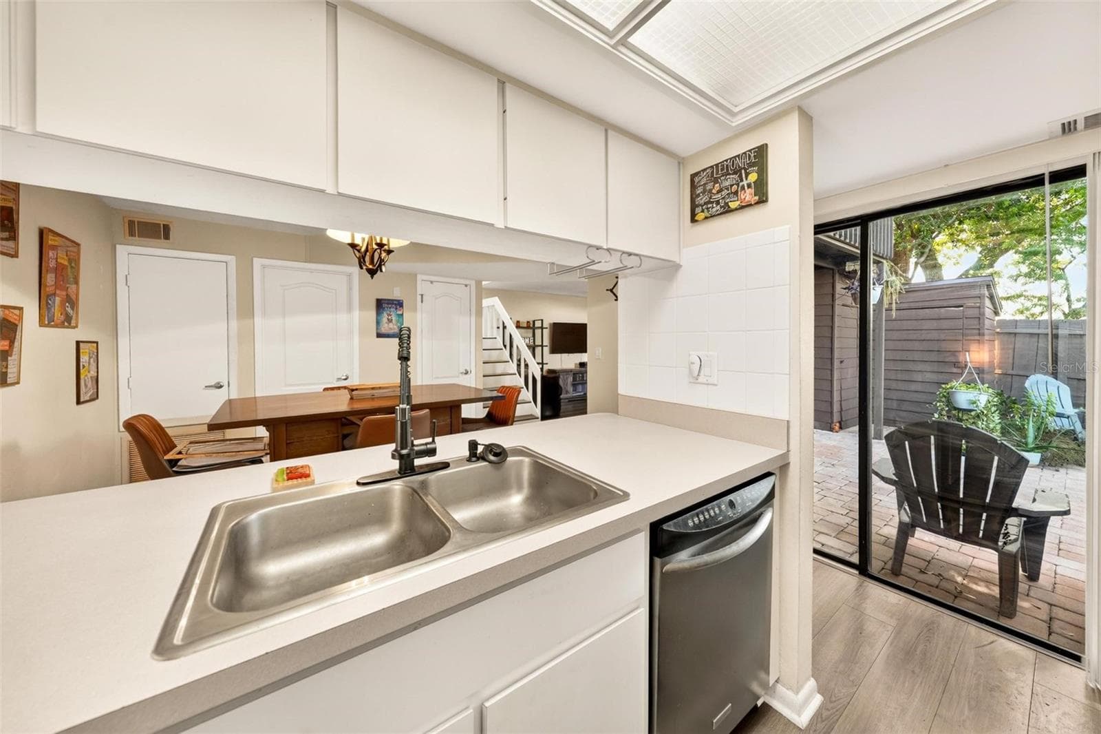 Kitchen with courtyard access through sliding glass doors. - 618 OLYMPIC DR #6A, OCOEE