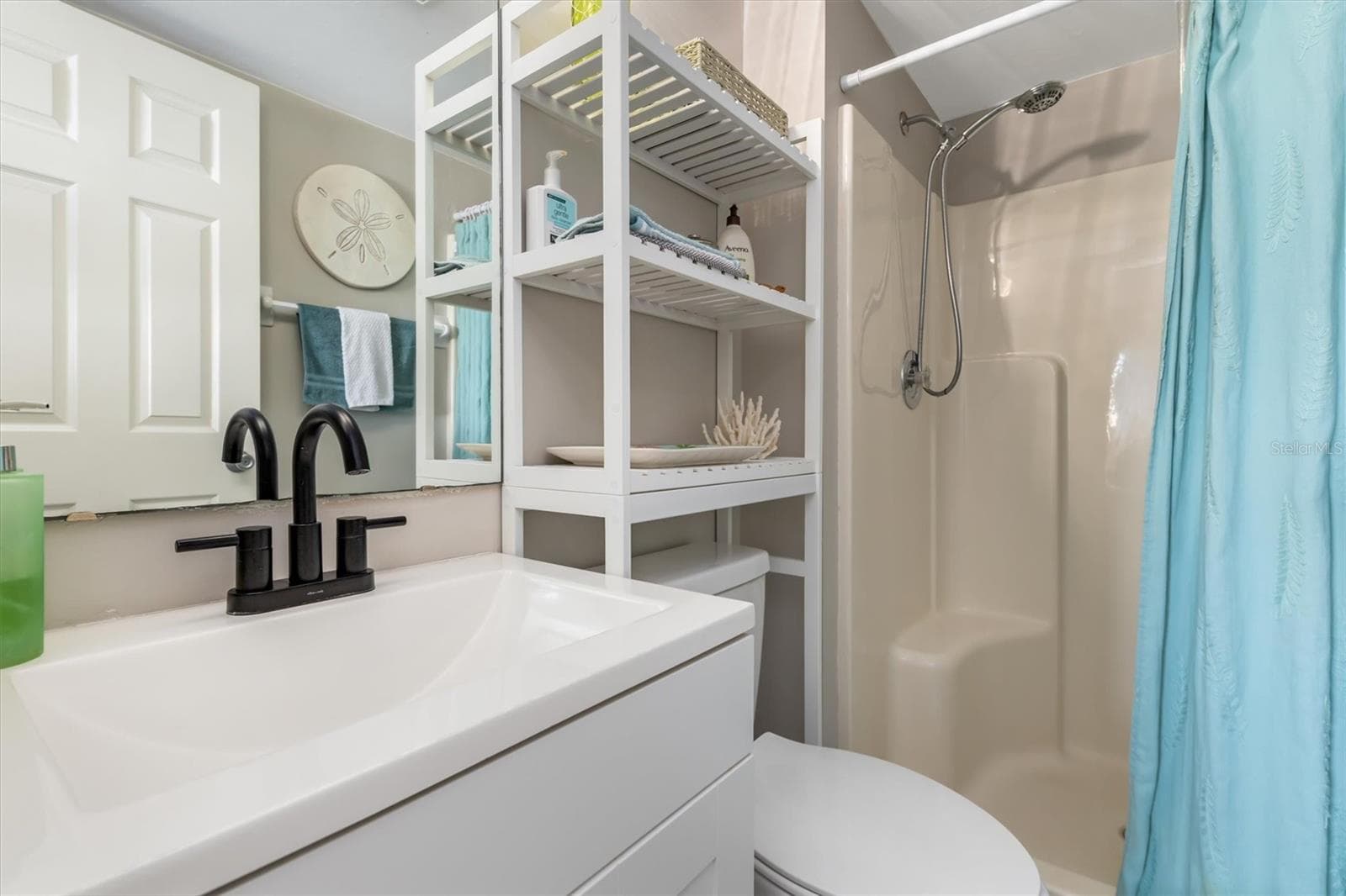 PRIMARY WALK IN SHOWER SOLID SURFACE COUNTER. - 3310 LOVELAND BLVD #1105, PUNTA GORDA