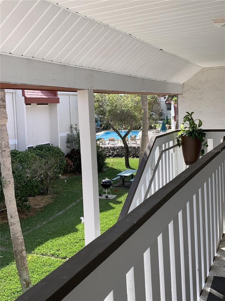 View from front porch with pool only 25 steps to the pool and 3 minutes to the beach. - 1801 GULF DR N #219, BRADENTON BEACH
