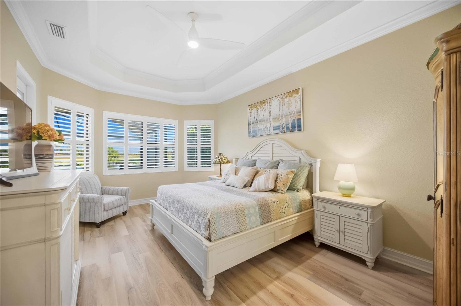 Primary Bedroom with entry to the lanai overlookiing the pool/spa - 10720 TARFLOWER DR, VENICE