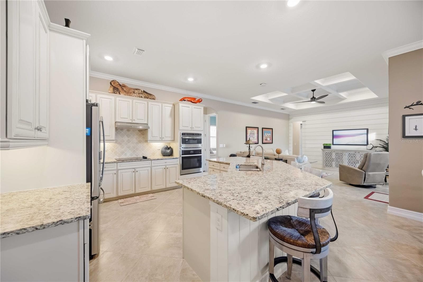 Upscale Kitchen with double ovens, dishwasher, cooktop, plenty of counter space, and dining on the counter. - 10720 TARFLOWER DR, VENICE