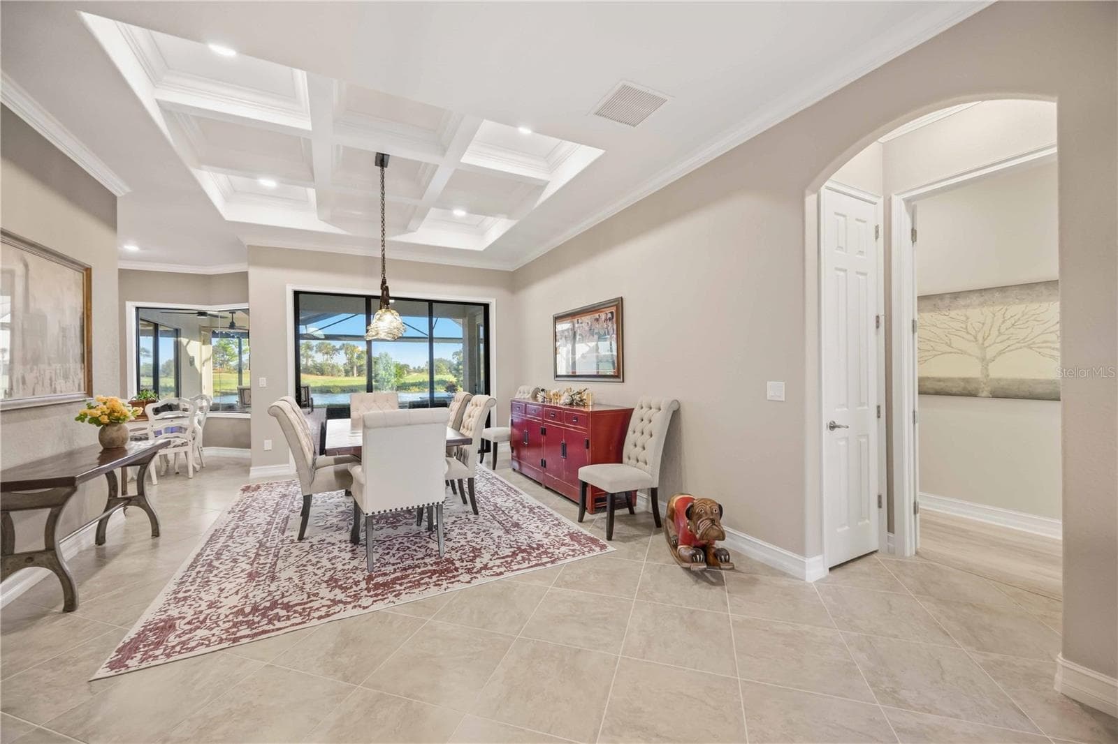 The primary bedroom entry is off the dining room. The owners added a closet and reconfigured the entry to the room for additional privacy - 10720 TARFLOWER DR, VENICE