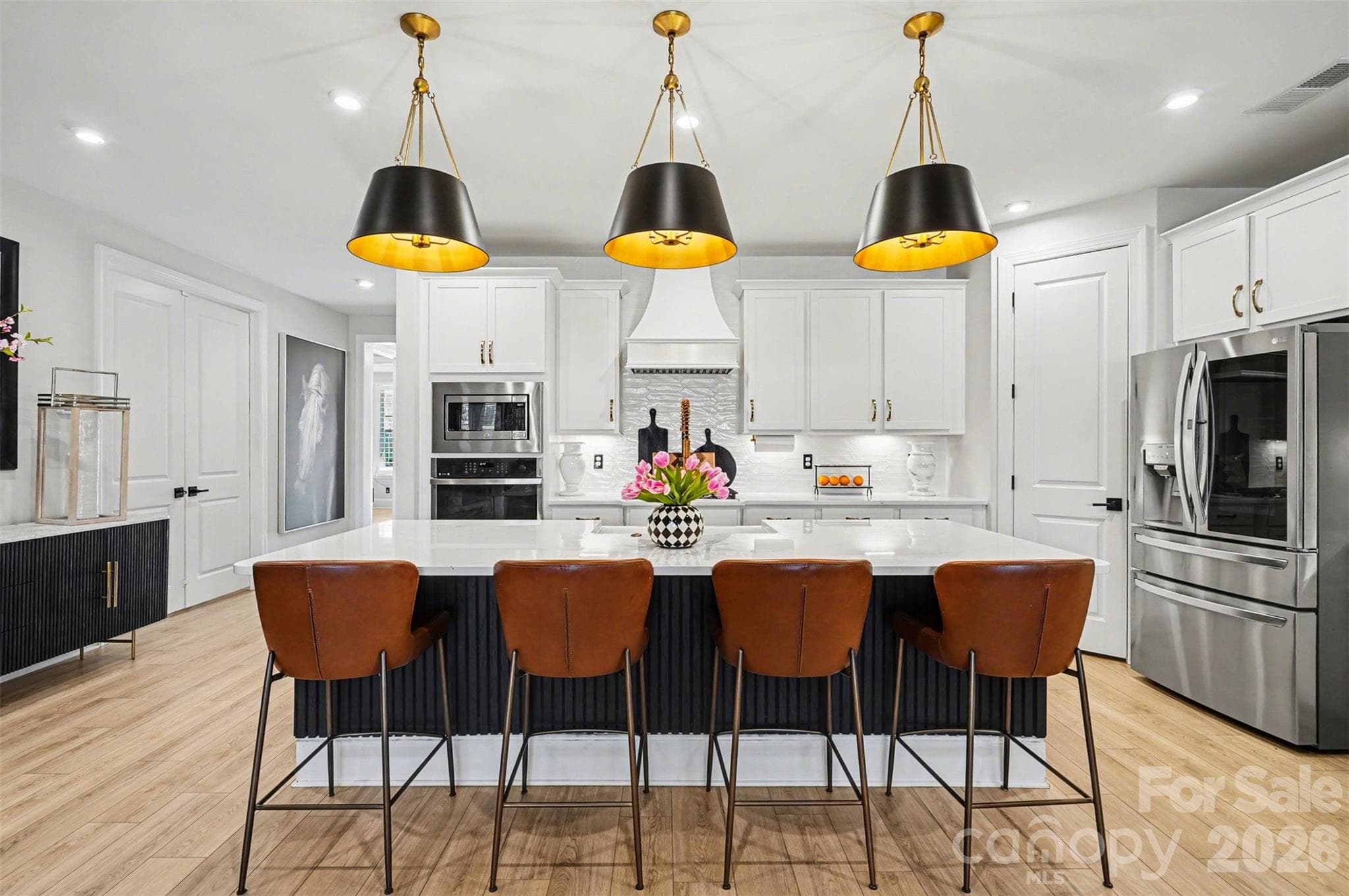Quartz counters, an oversized island, and a walk-in pantry. The kitchen is where everyone ends up. - 8027 Longwaters Court, York