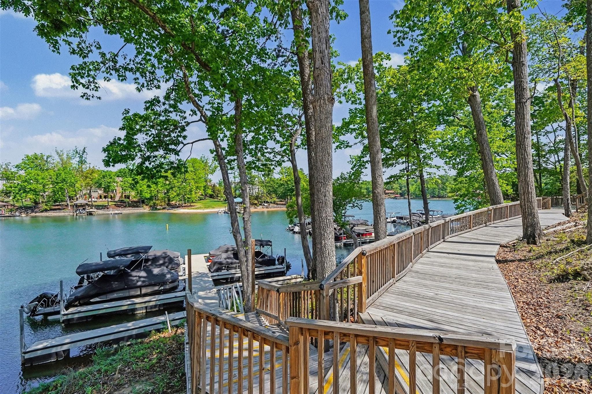 Boardwalk down to the community boat slips. Boat and jet ski slips, kayaks, and boat storage are available to rent. - 8027 Longwaters Court, York