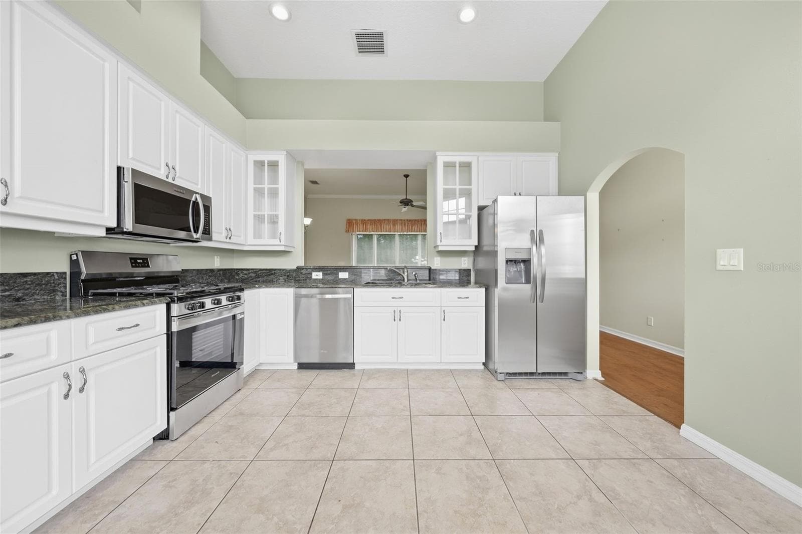 Spacious kitchen featuring granite countertops, stainless steel appliances, abundant cabinetry, and generous workspace. - 5596 FREEPORT DR, TAVARES