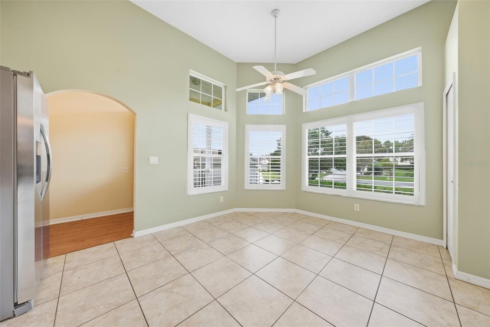 Sun-filled breakfast nook featuring valuted ceilings, expansive windows, and plantation shutters. - 5596 FREEPORT DR, TAVARES