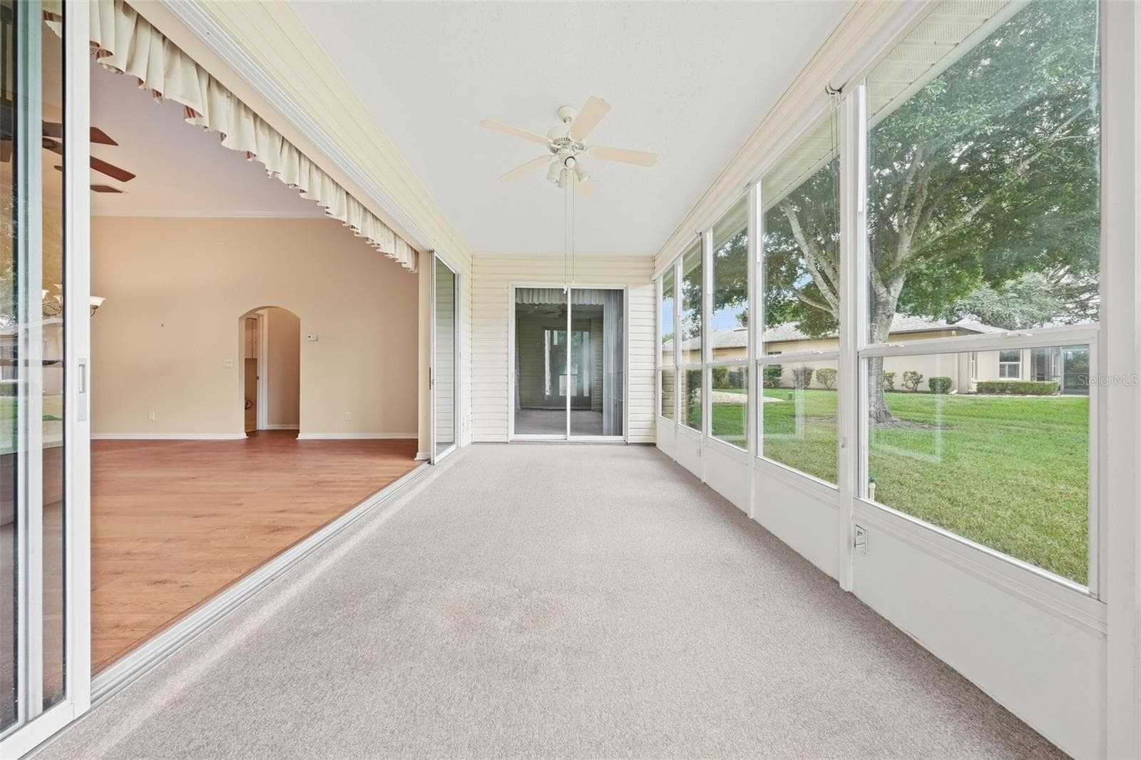 Spacious enclosed Florida room with walls of windows, abundant natural lights, and seamless access to the main living area. - 5596 FREEPORT DR, TAVARES