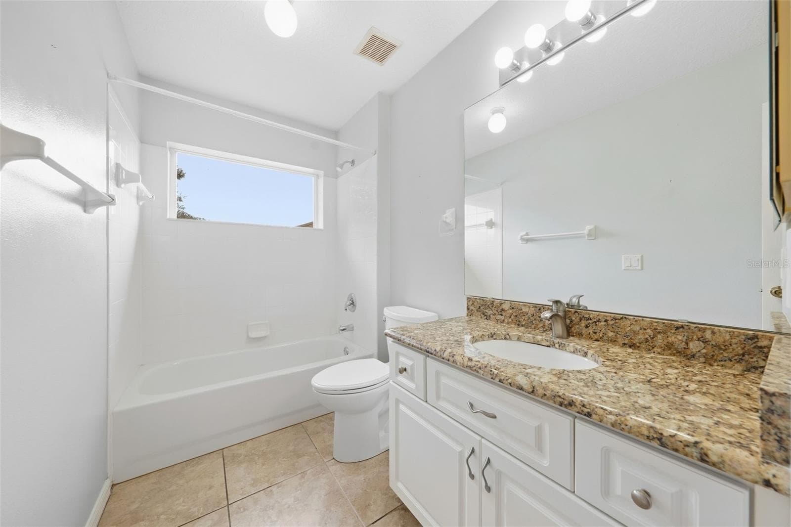 2nd bath....featuring a granite vanity, generous counter space, and convenient walk-in shower. - 5596 FREEPORT DR, TAVARES