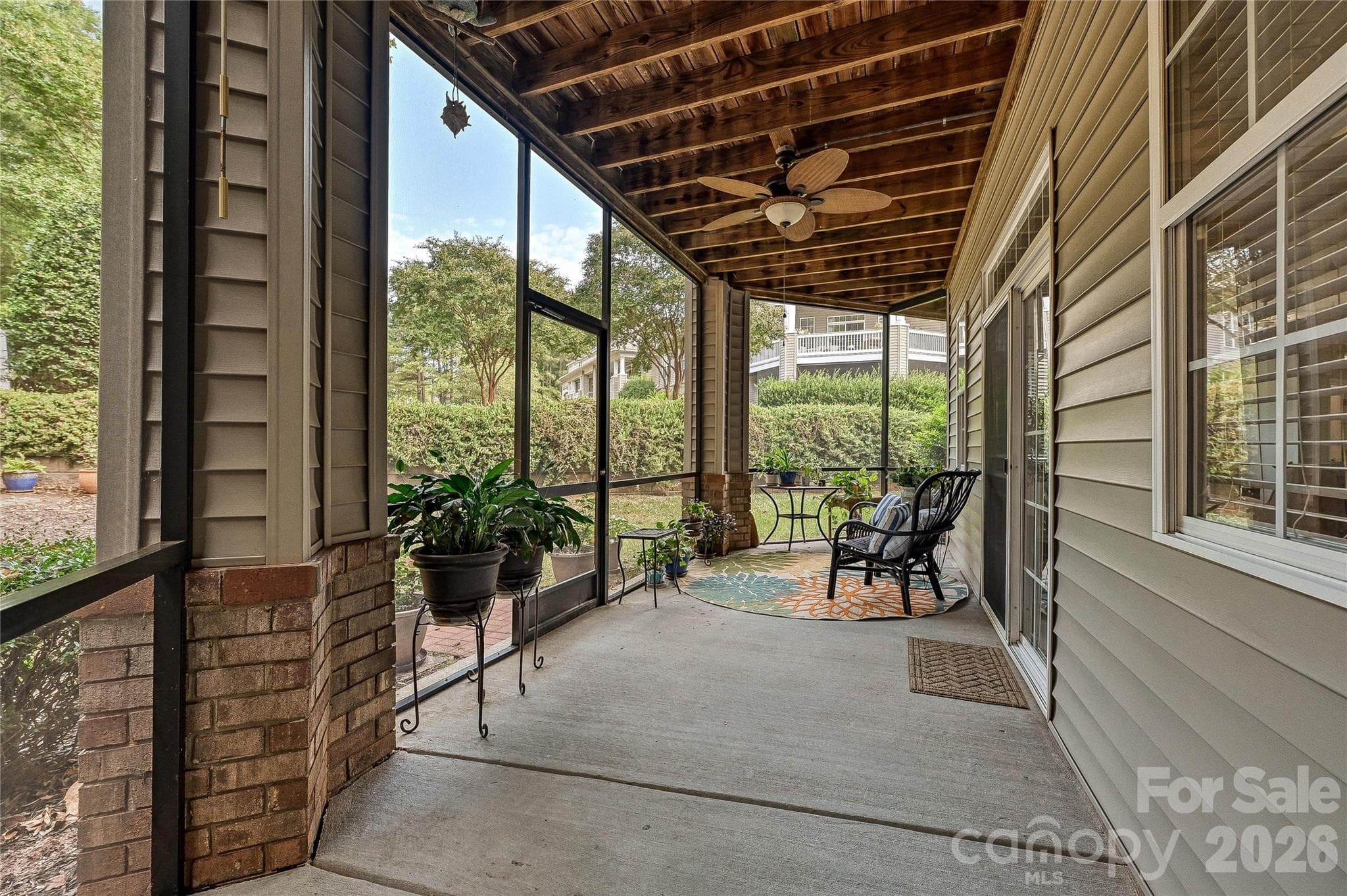 Covered screened porch extends the living space outdoors with ceiling fans and a peaceful setting for relaxing or entertaining. - 9009 Rosalyn Glen Road, Cornelius