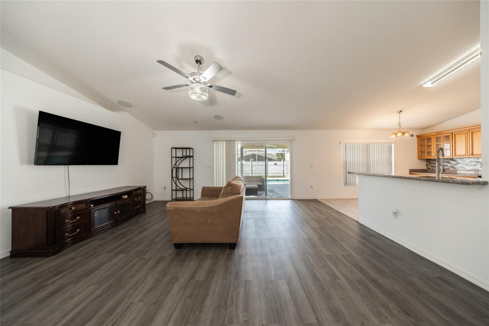 large family room & LVP flooring throughout, except kitchen, foyer & primary bath which are tile - 11 LANCASTER LN, PALM COAST