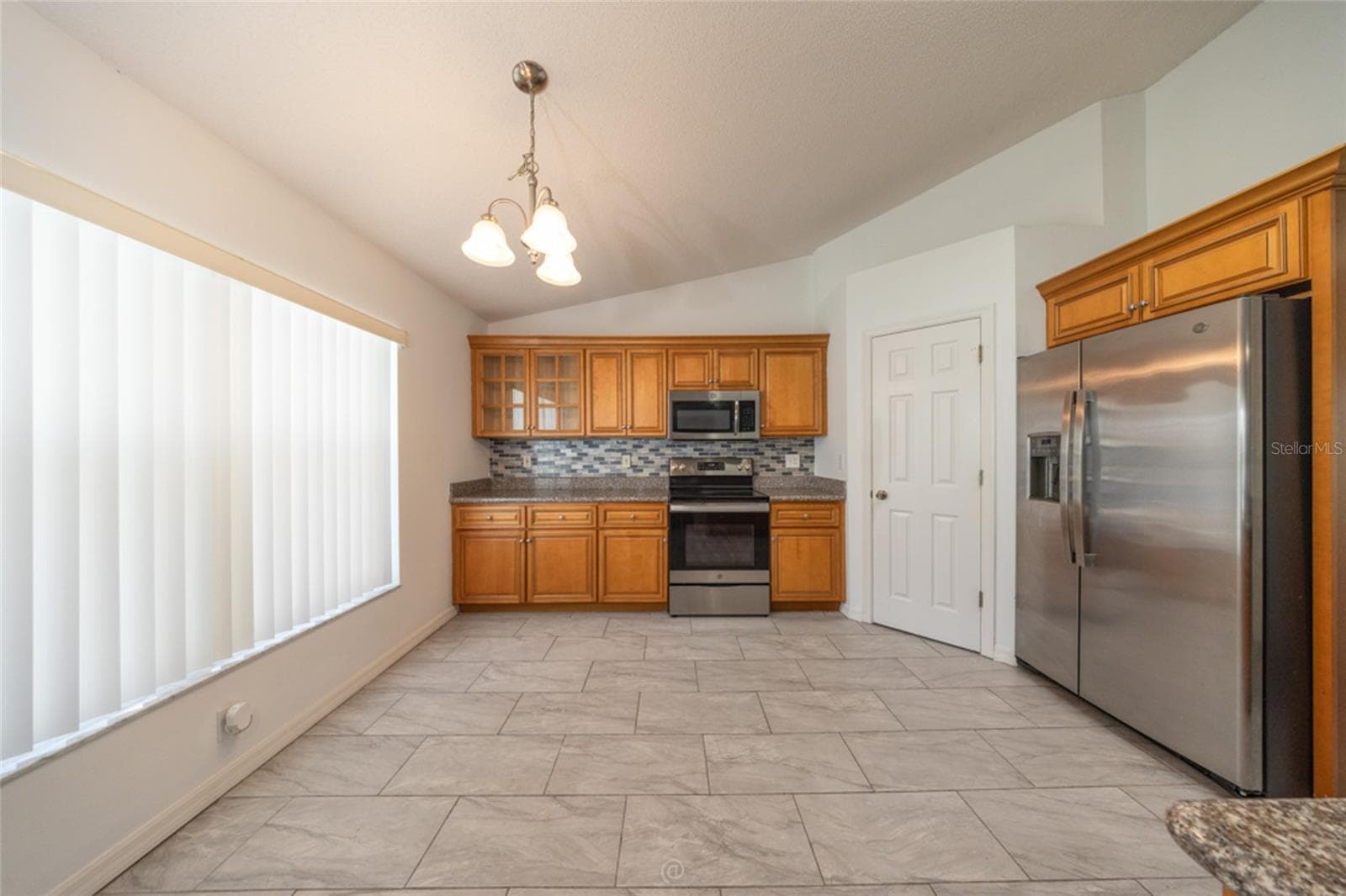 view from family room into the kitchen - 11 LANCASTER LN, PALM COAST