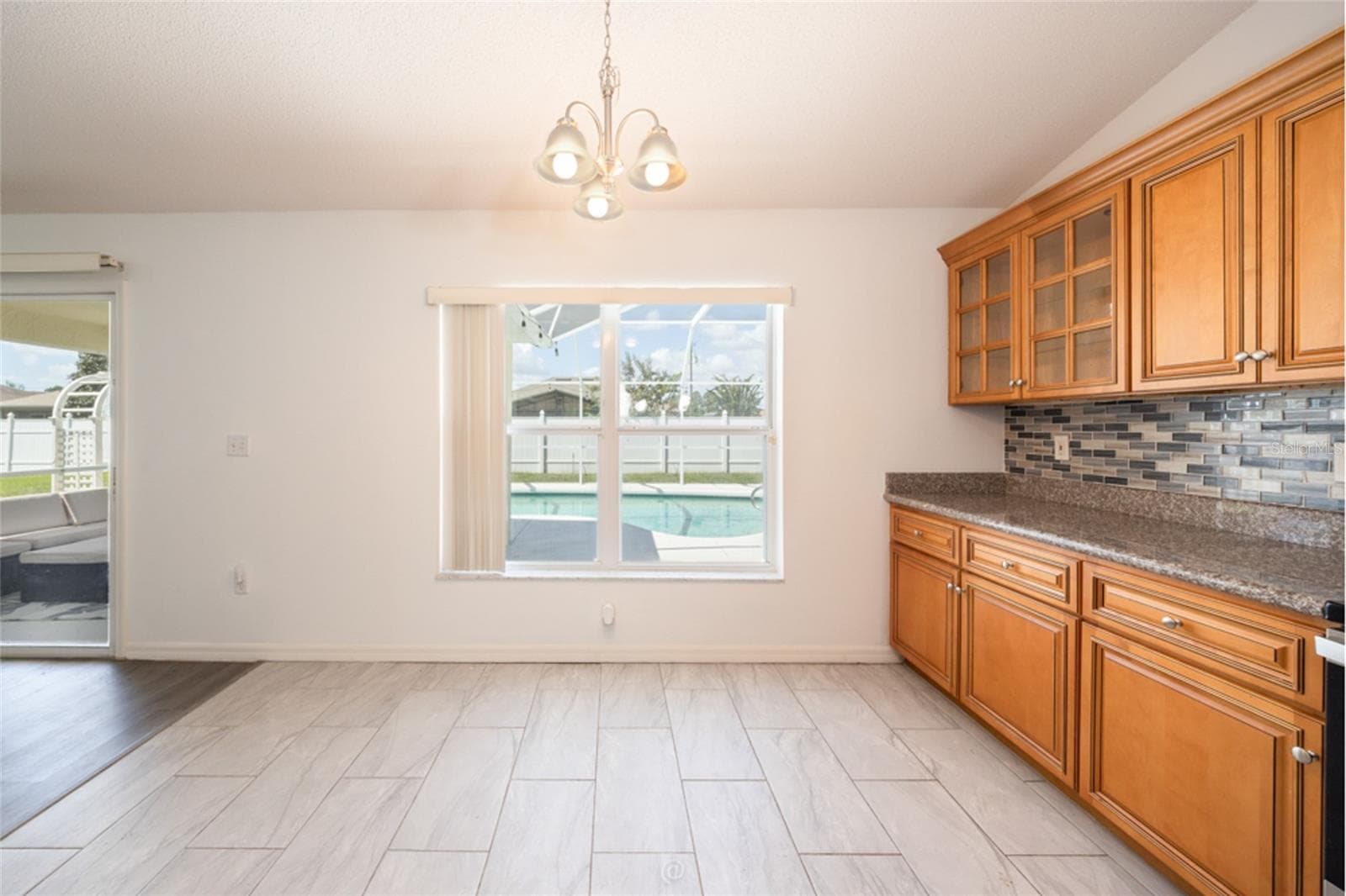 plenty of room for a table, with a view of the pool - 11 LANCASTER LN, PALM COAST