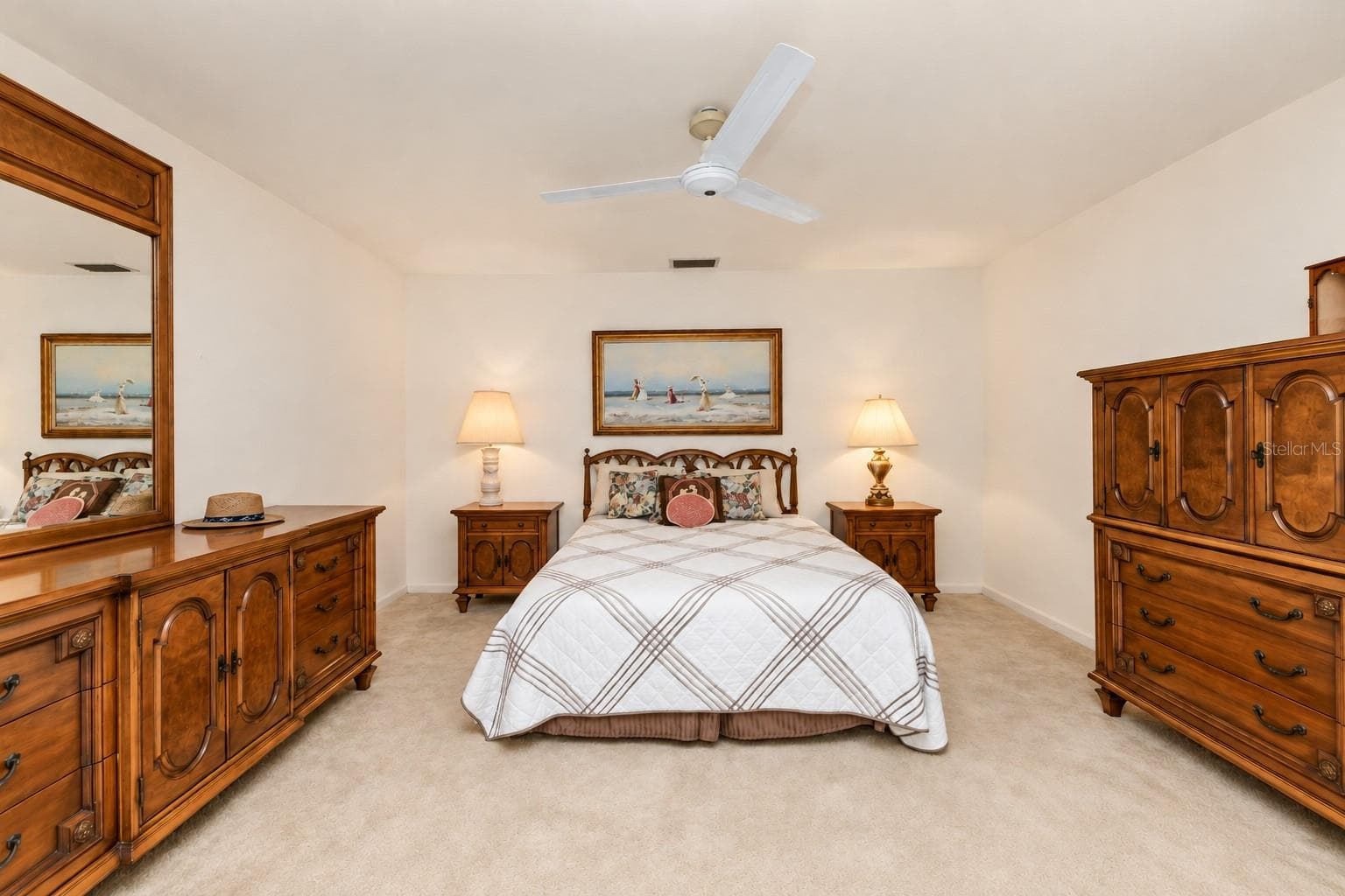 Primary bedroom (bed room 1) with double closets, ceiling fan, ensuite bathroom (shower only), and sliders to waterfront backyard. - 160 ANNAPOLIS LN, ROTONDA WEST
