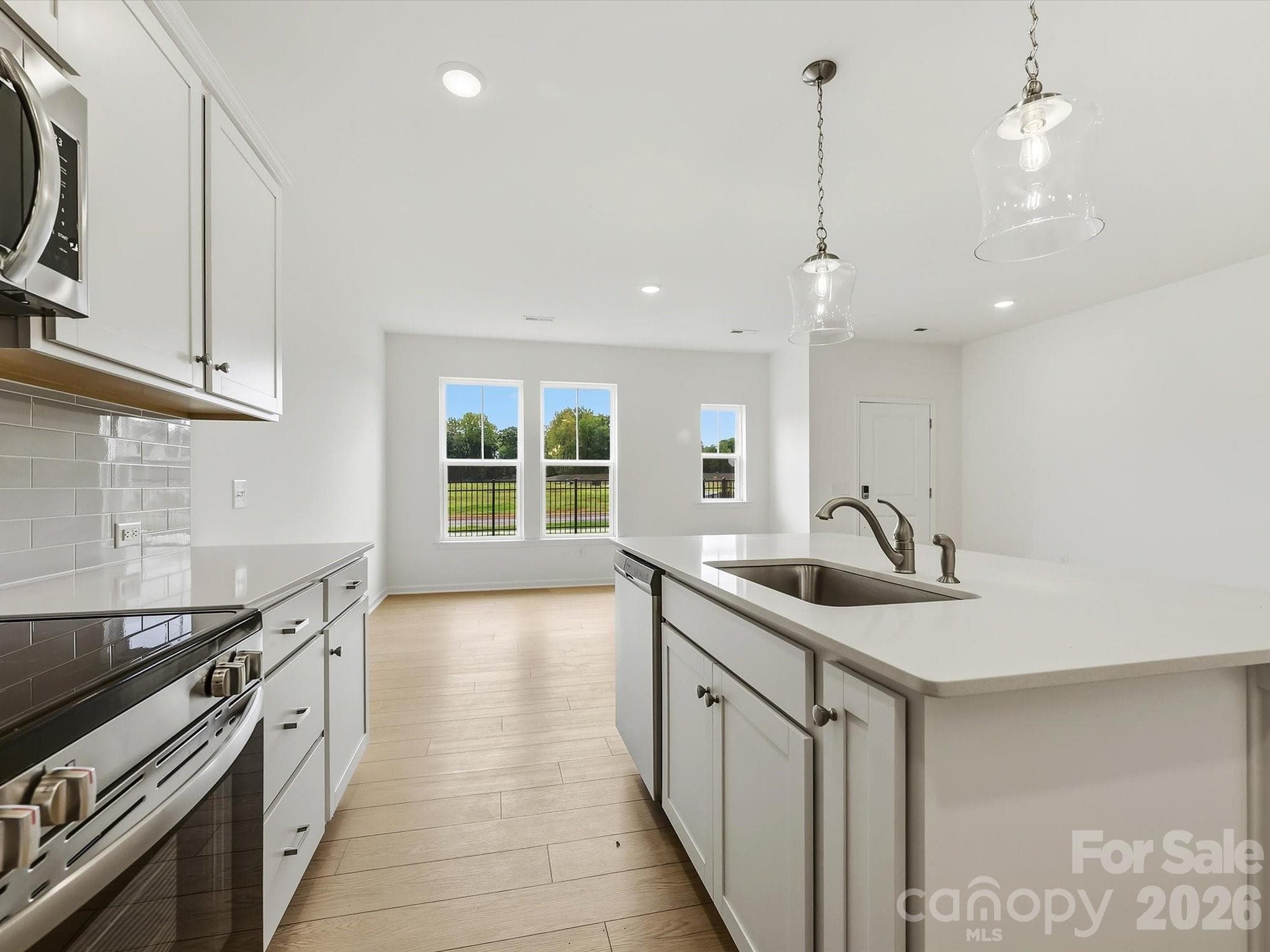 Kitchen Leading into Living Room and Dining Area Offering an Open Floorplan, Perfect for Entertaining - 6613 Fire Lily Lane, Charlotte