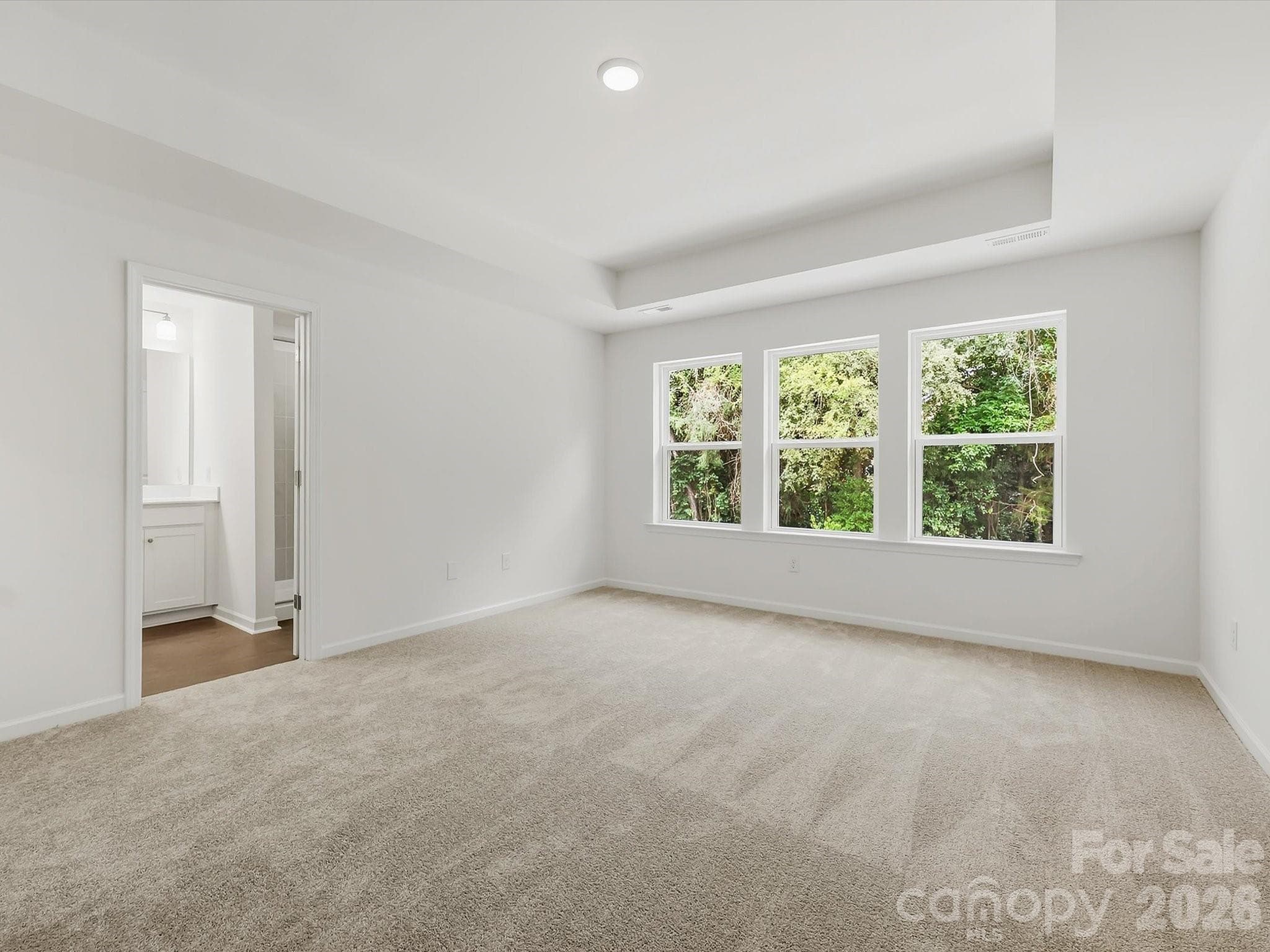 Owner's Suite Offers an Abundance of Natural Light Backing up to the Woods for Privacy and Nature - 6613 Fire Lily Lane, Charlotte