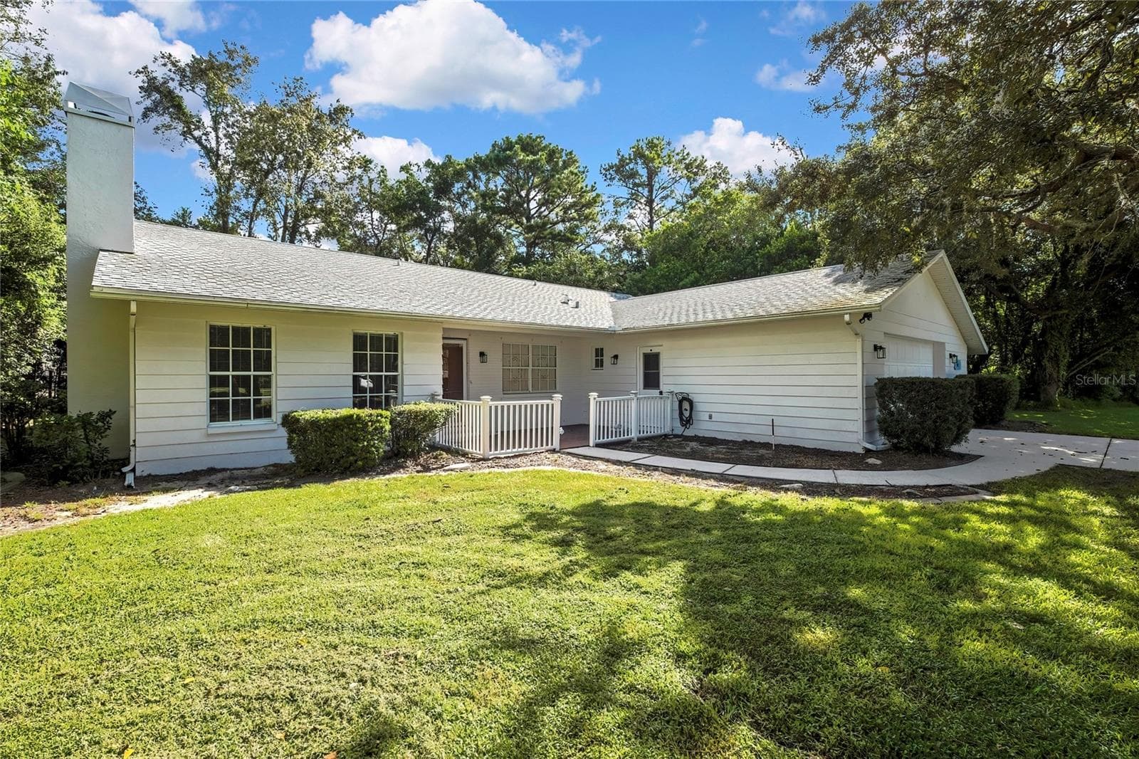 Rear view of the home and screen-enclosed pool - 1097 FLORIAN WAY, SPRING HILL