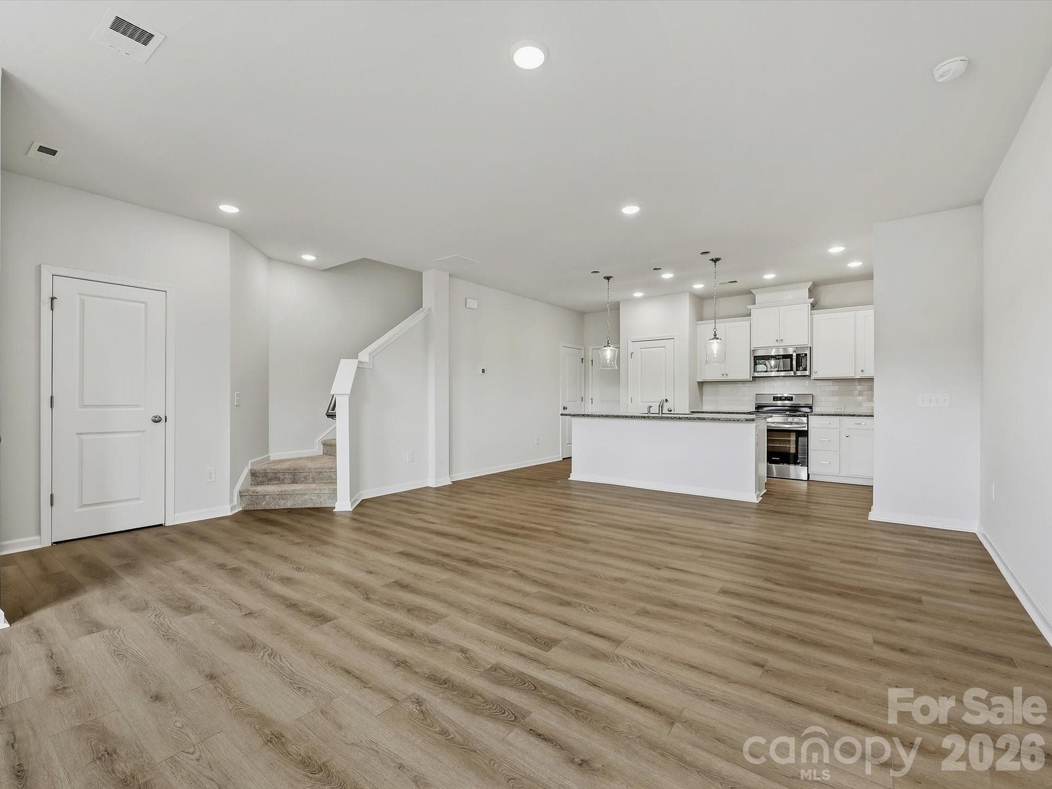 Spacious Living Room Flowing Seemlessly into Dining Area and Kitchen - 6609 Fire Lily Lane, Charlotte