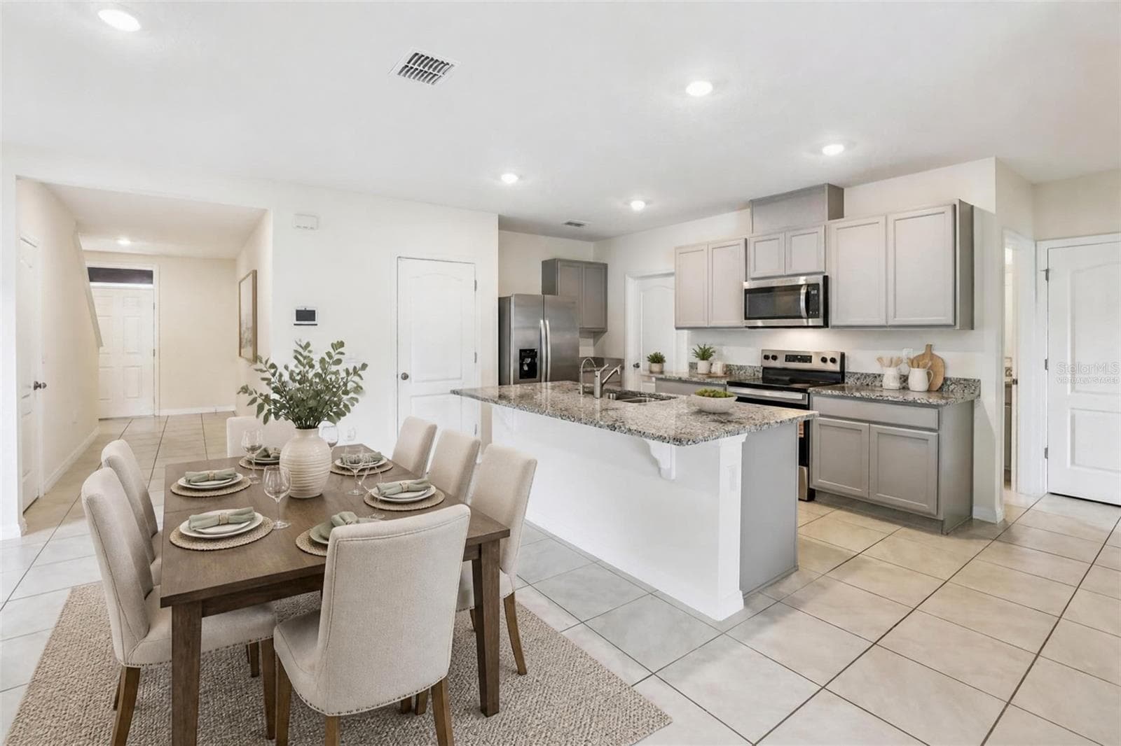 Virtually staged dining kitchen combo - 2945 ELIO HAMMOCK DR, HARMONY