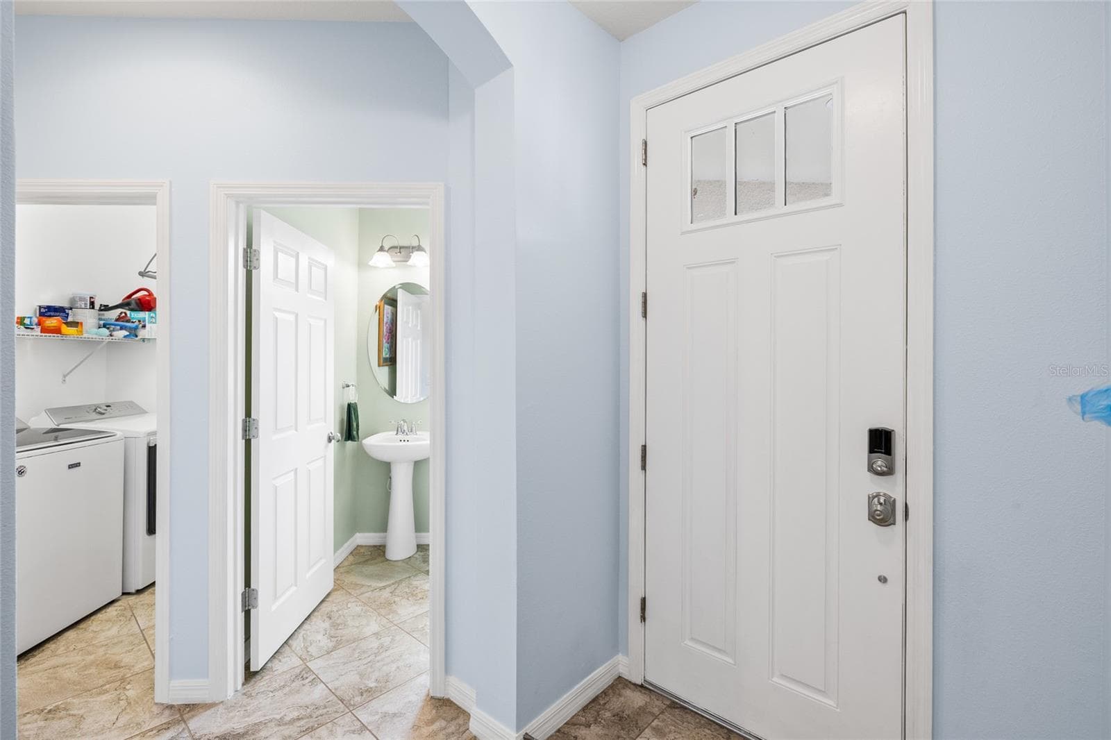 Foyer looking toward half bath and interior laundry room - 8519 ARABELLA LN, SEMINOLE